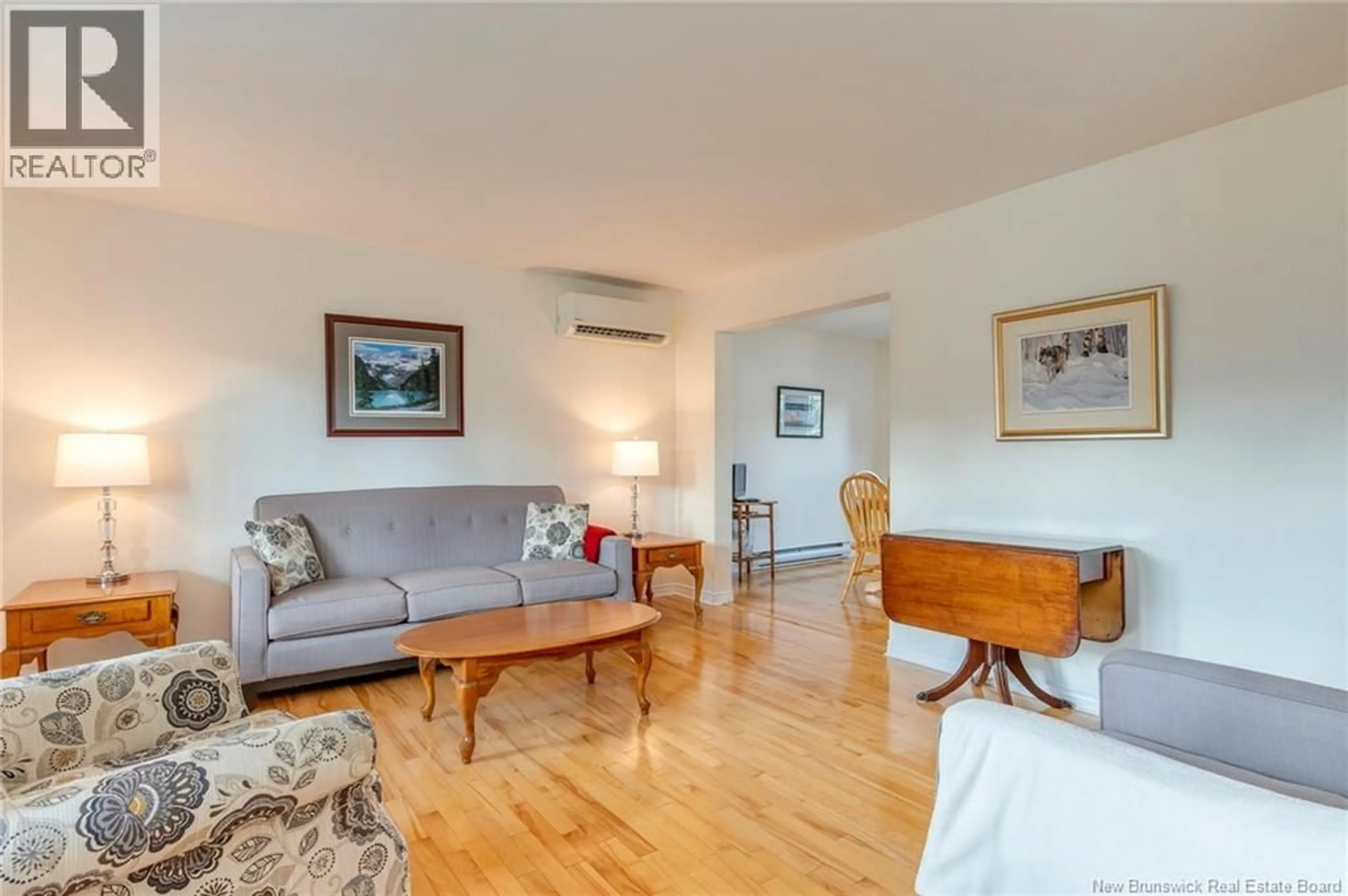 Living room with furniture, wood/laminate floor for 111 BRIDLEWOOD WAY, Moncton New Brunswick E1G2H7