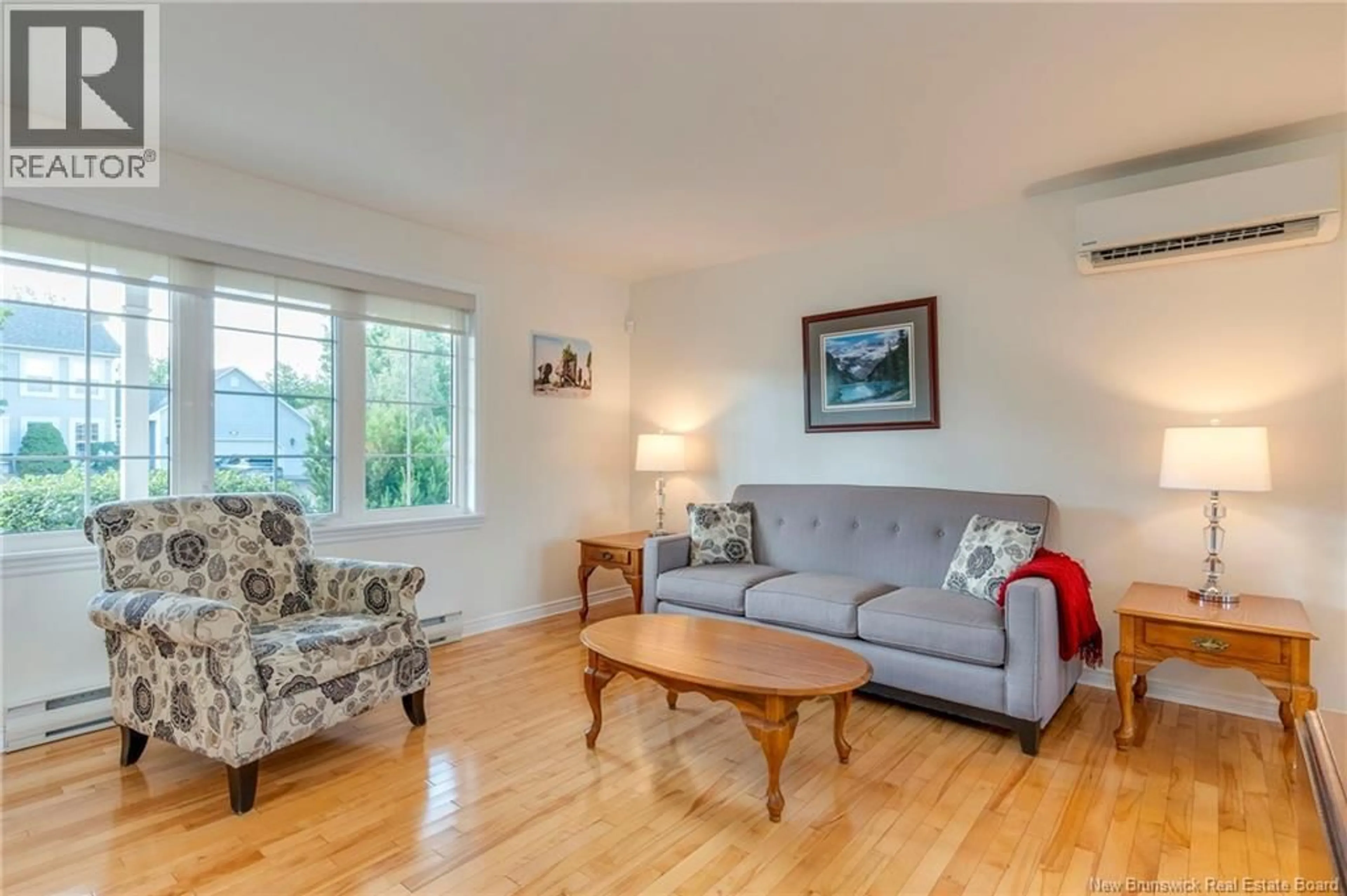 Living room with furniture, wood/laminate floor for 111 BRIDLEWOOD WAY, Moncton New Brunswick E1G2H7
