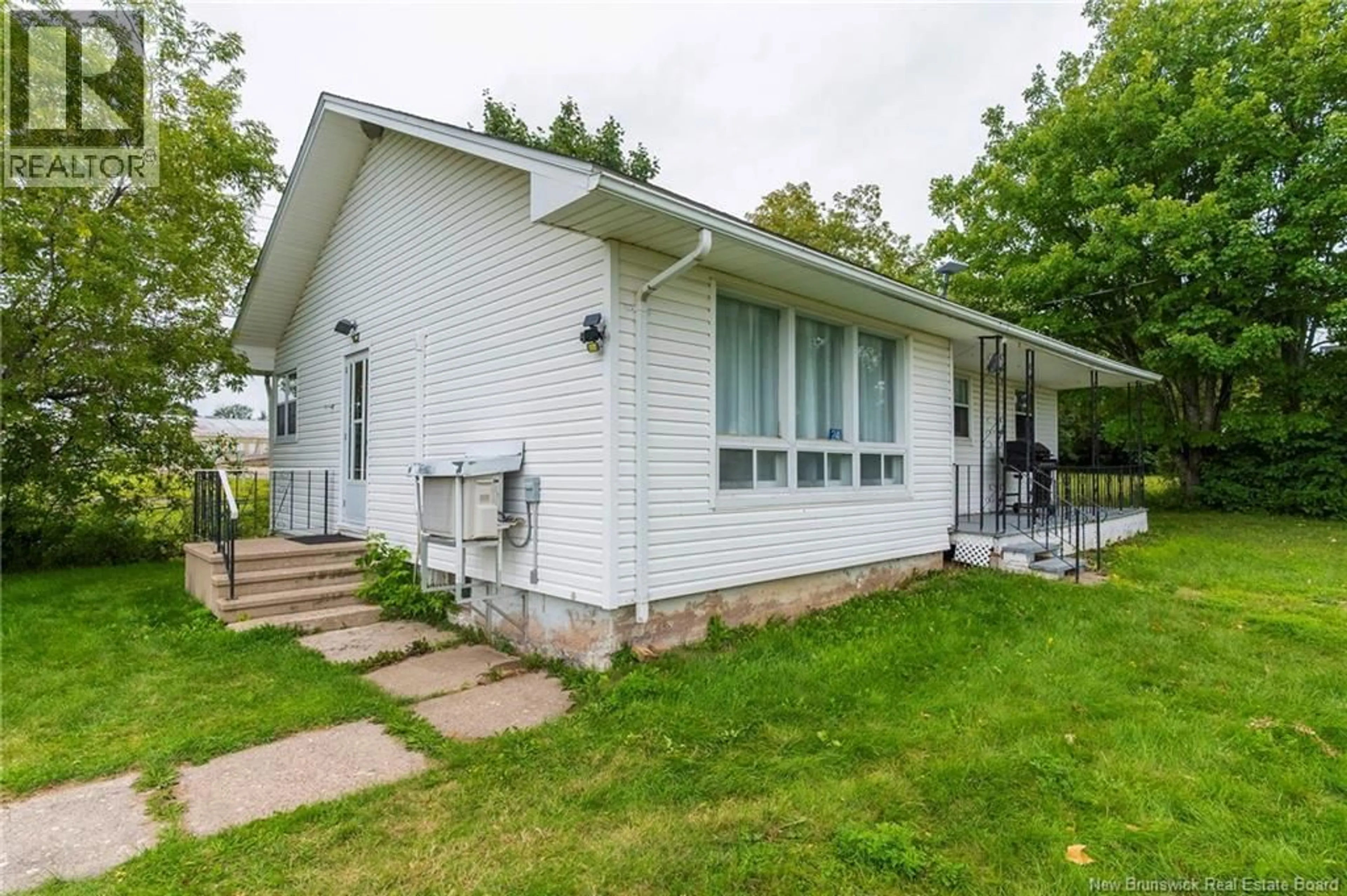 Home with vinyl exterior material, street for 24 RUE DE L'EGLISE, Bouctouche New Brunswick E4S2Z8