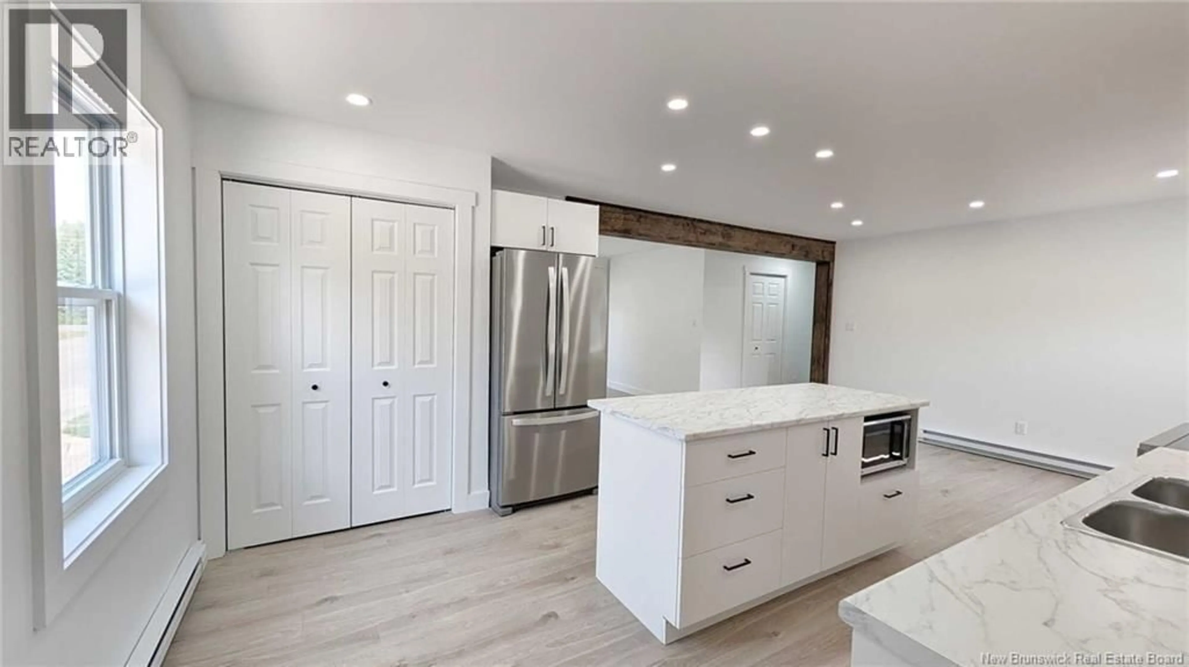 Open concept kitchen, wood/laminate floor for 1318 CHEM. SAULNIER O, Saumarez New Brunswick E1X2J5