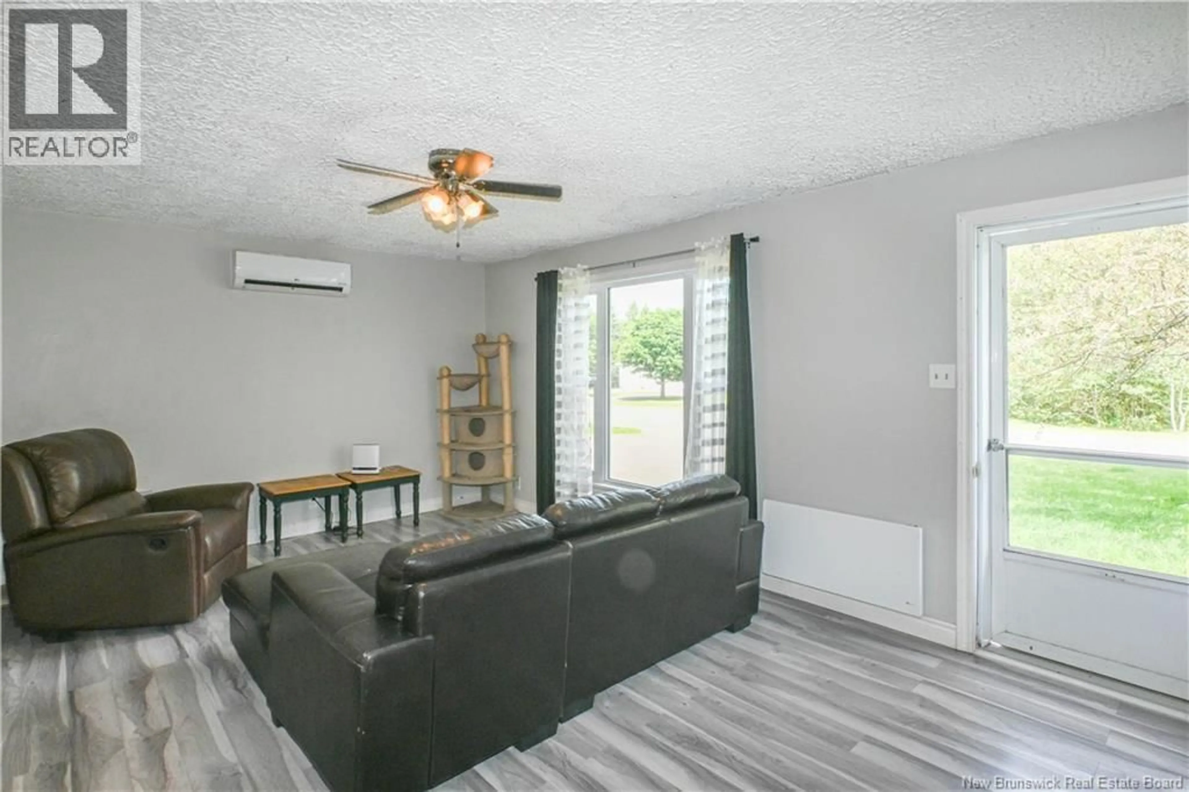Living room with furniture, wood/laminate floor for 564 SAINT-JOSEPH BOULEVARD, Saint-Léolin New Brunswick E8N2N1