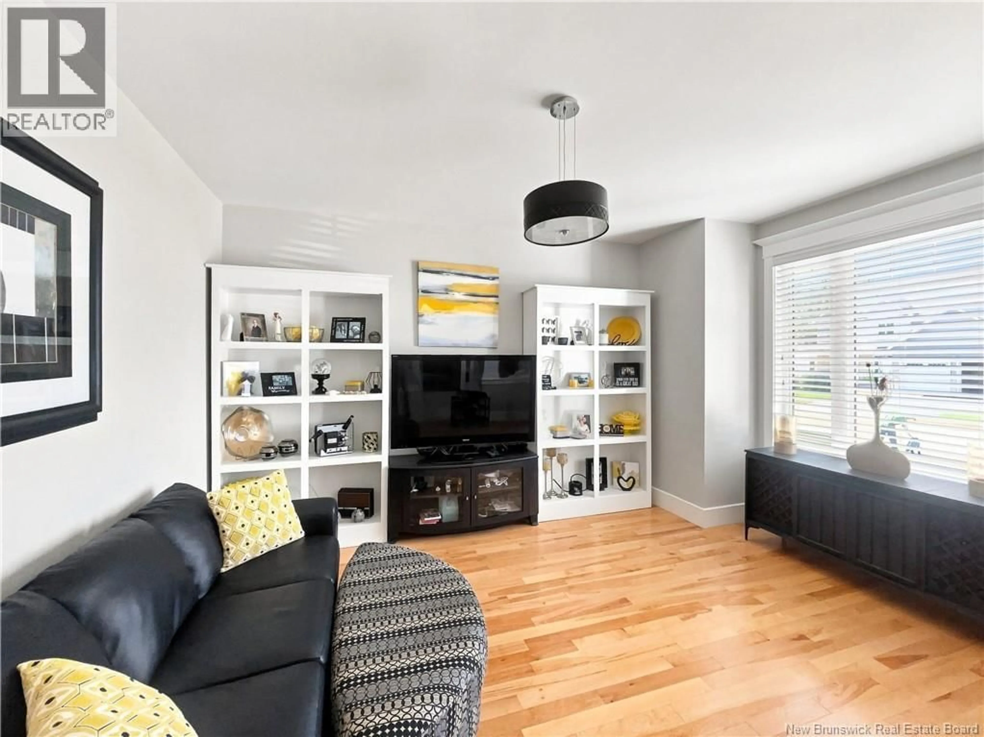 Living room with furniture, wood/laminate floor for 33 ANNFIELD COURT, Moncton New Brunswick E1G0N9