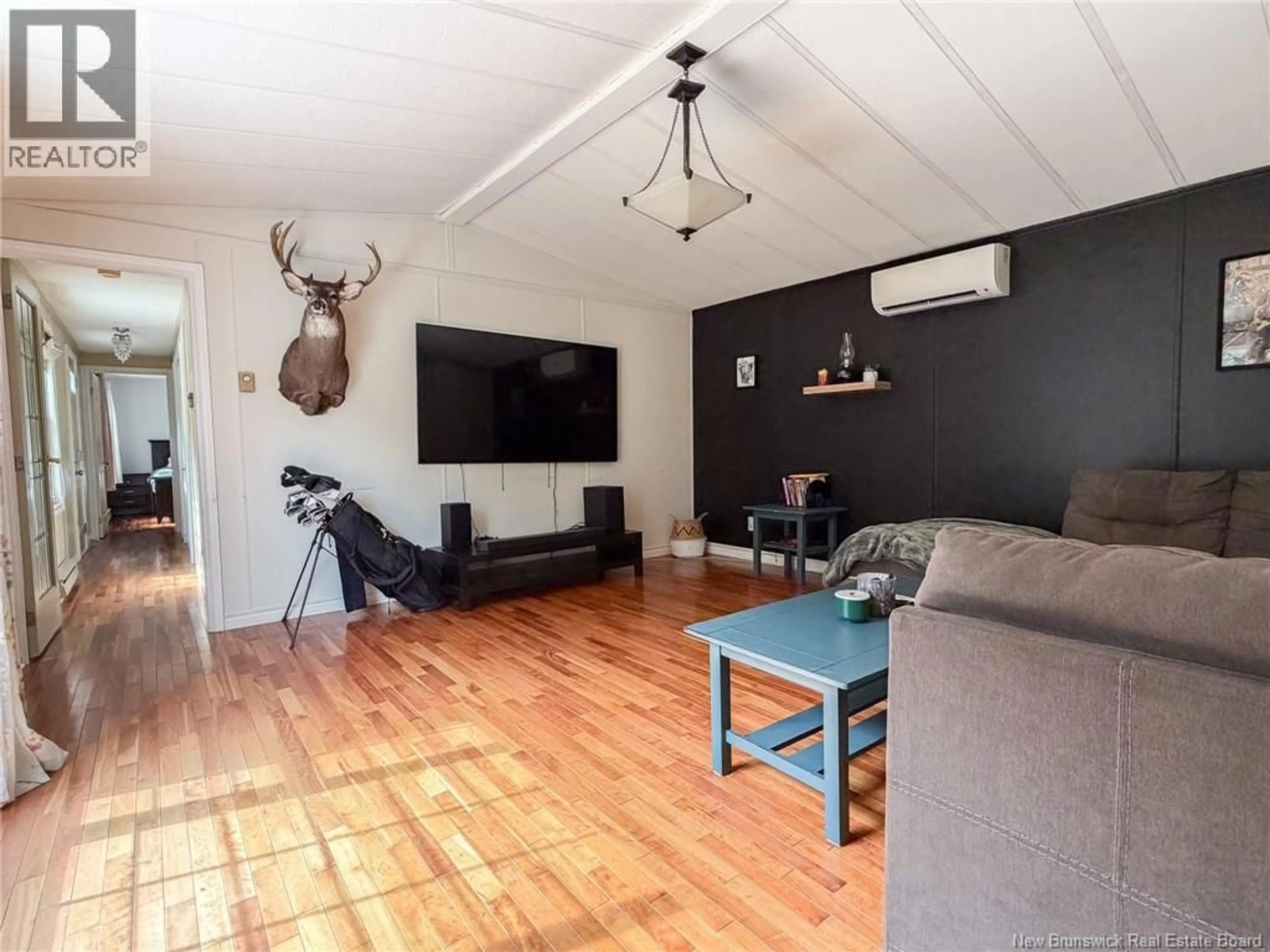 Living room with furniture, wood/laminate floor for 153 MOORE STREET, Fredericton New Brunswick E3B8L8