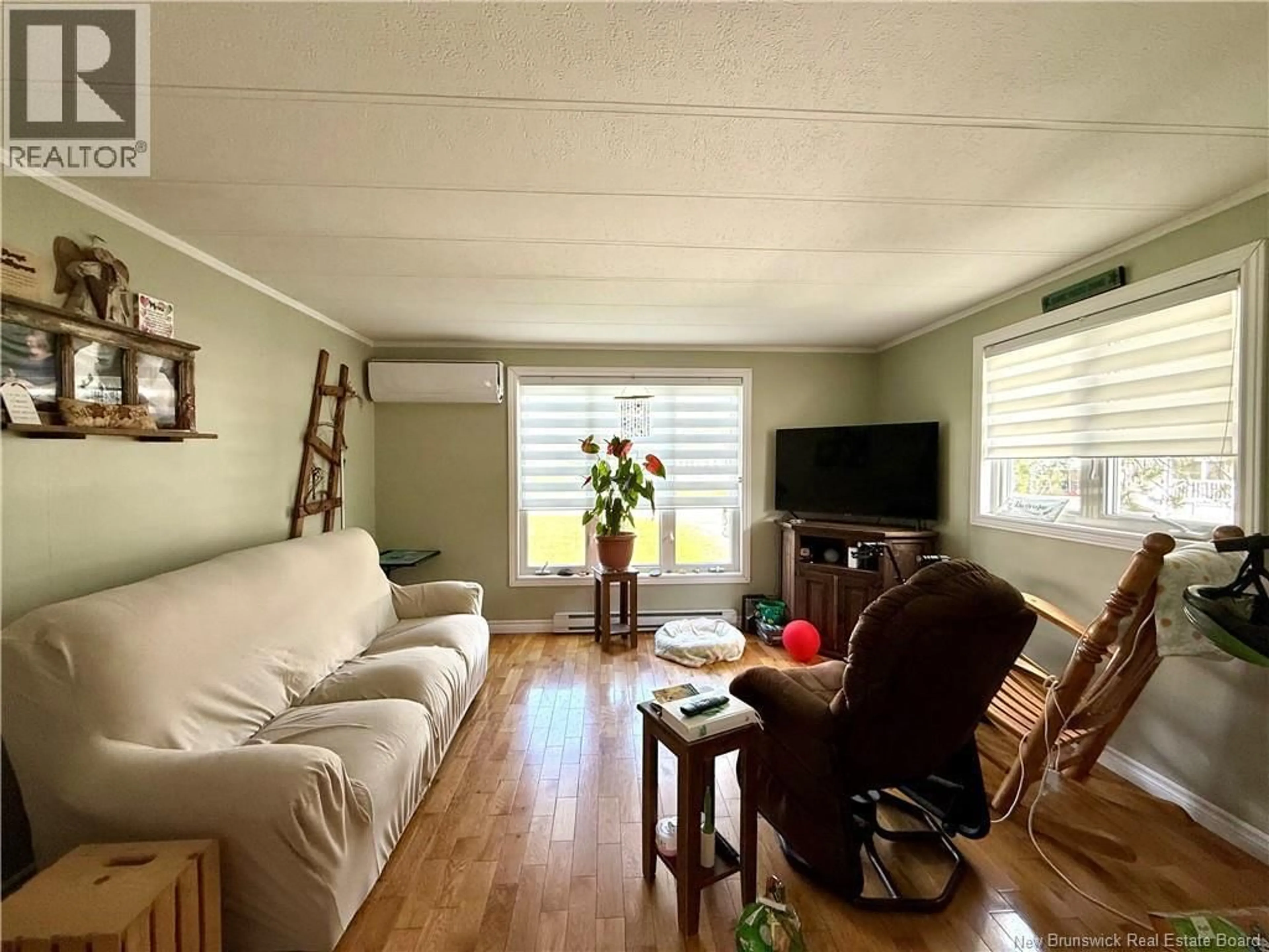 Living room with furniture, wood/laminate floor for 29 PARC P'TISO STREET, Edmundston New Brunswick E3V3X7
