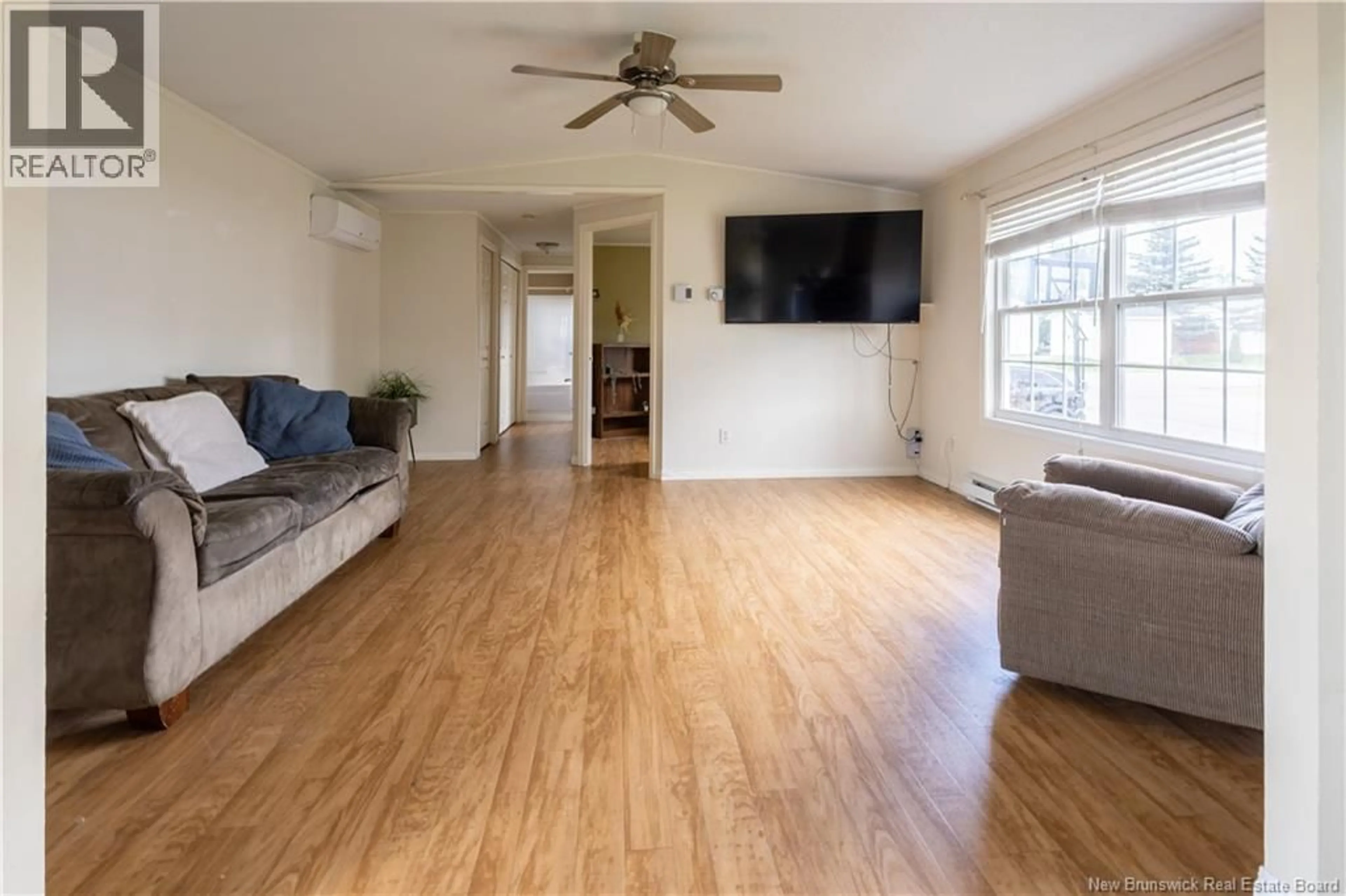 Living room with furniture, wood/laminate floor for 1 INGLEWOOD STREET, Moncton New Brunswick E1H3K5