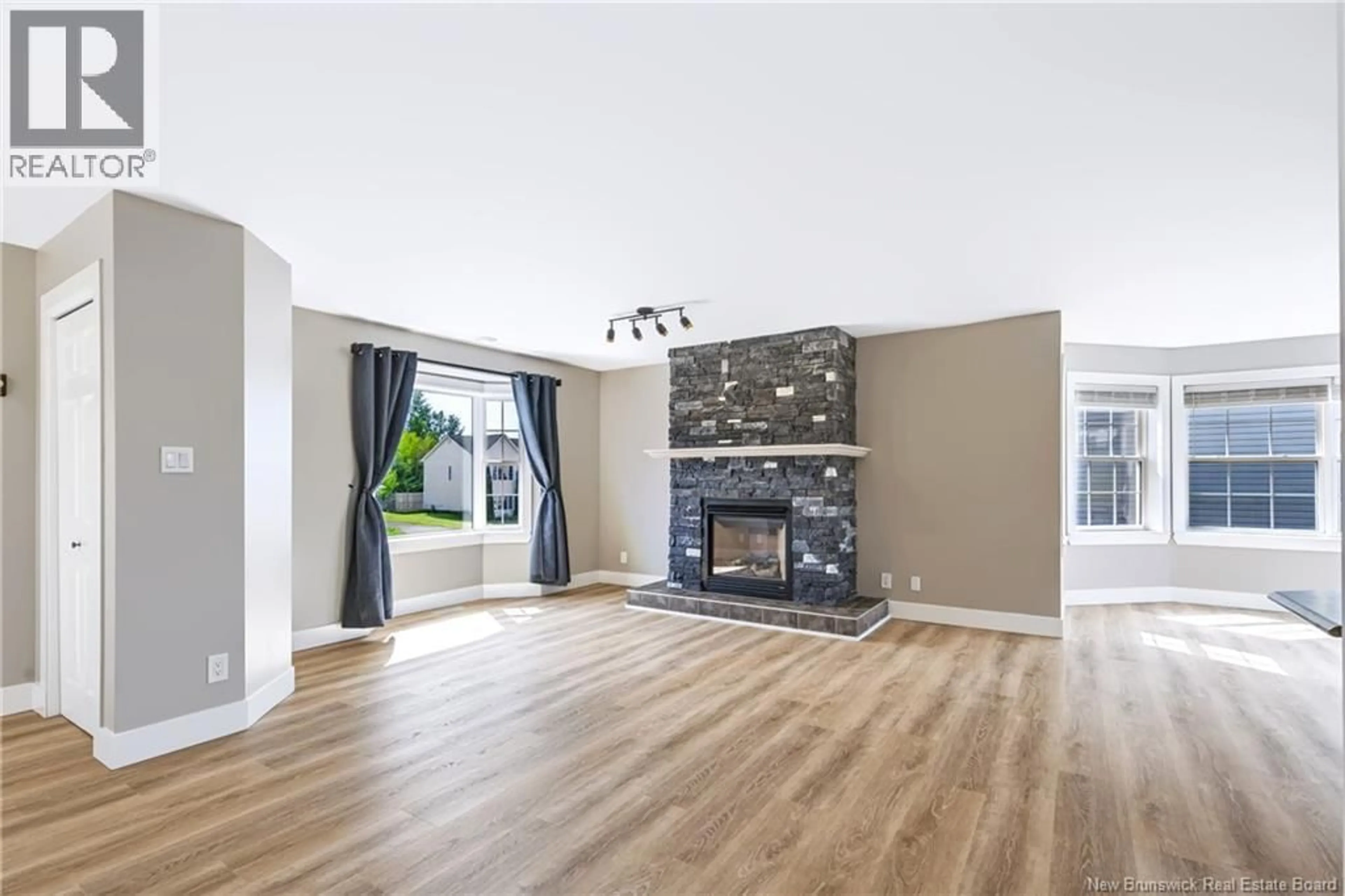 Living room with furniture, wood/laminate floor for 33 HALLIHAN DRIVE, Oromocto New Brunswick E2V0C2