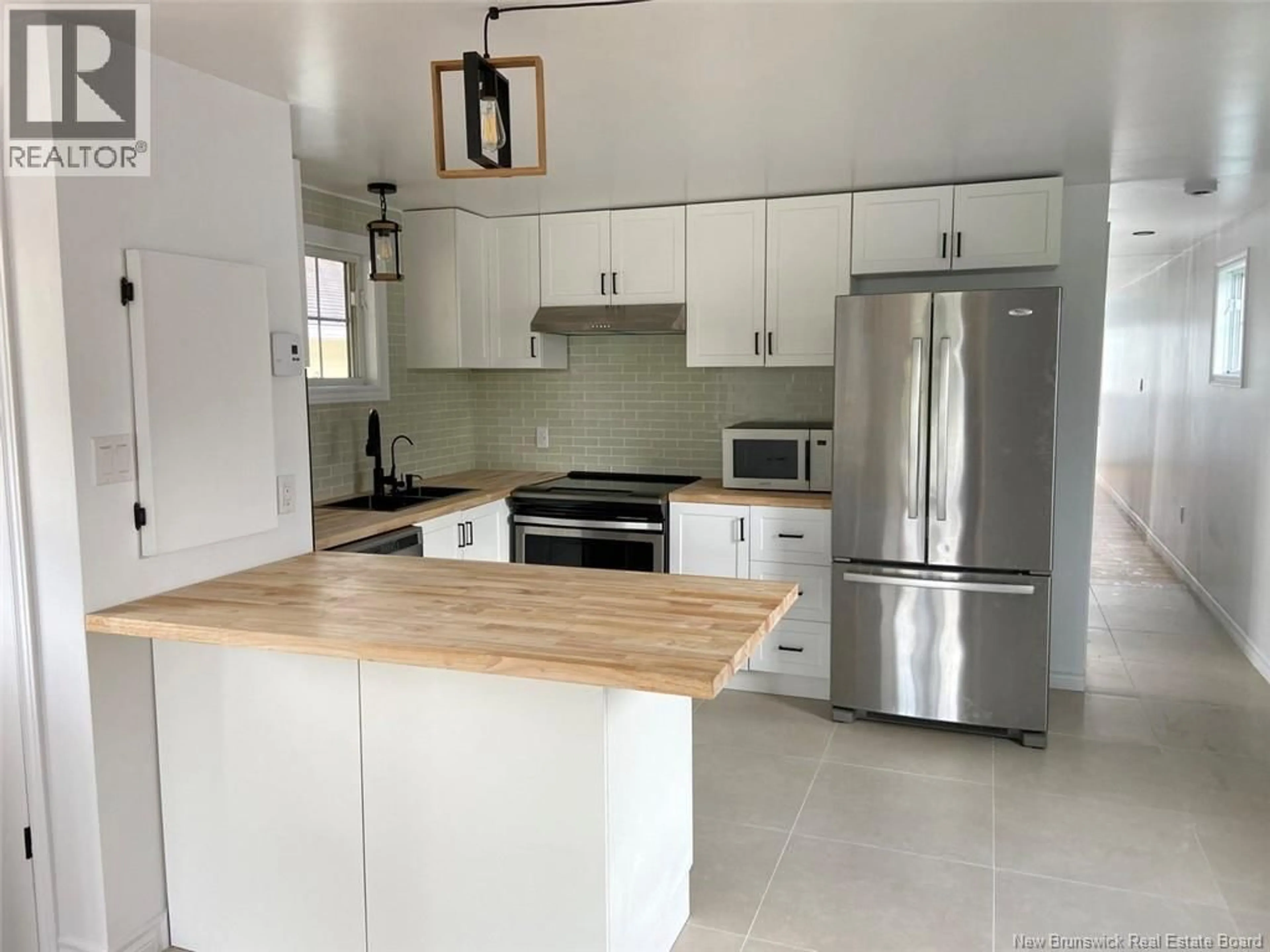 Open concept kitchen, ceramic/tile floor for 28 LE PARADIS STREET, Saint-Jacques New Brunswick E7B1T7