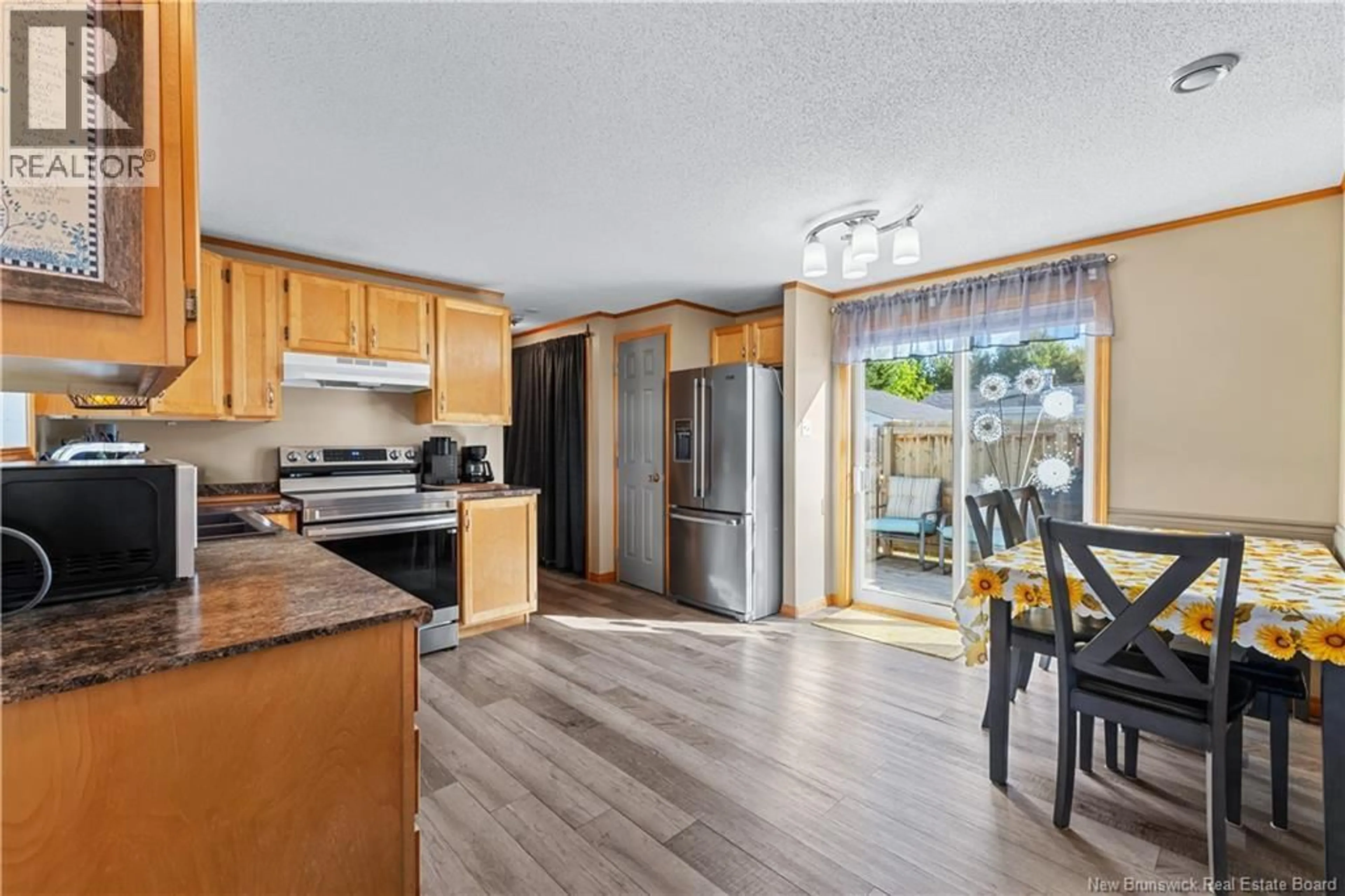 Open concept kitchen, wood/laminate floor for 10 PERIDOT STREET, Moncton New Brunswick E1H3E5
