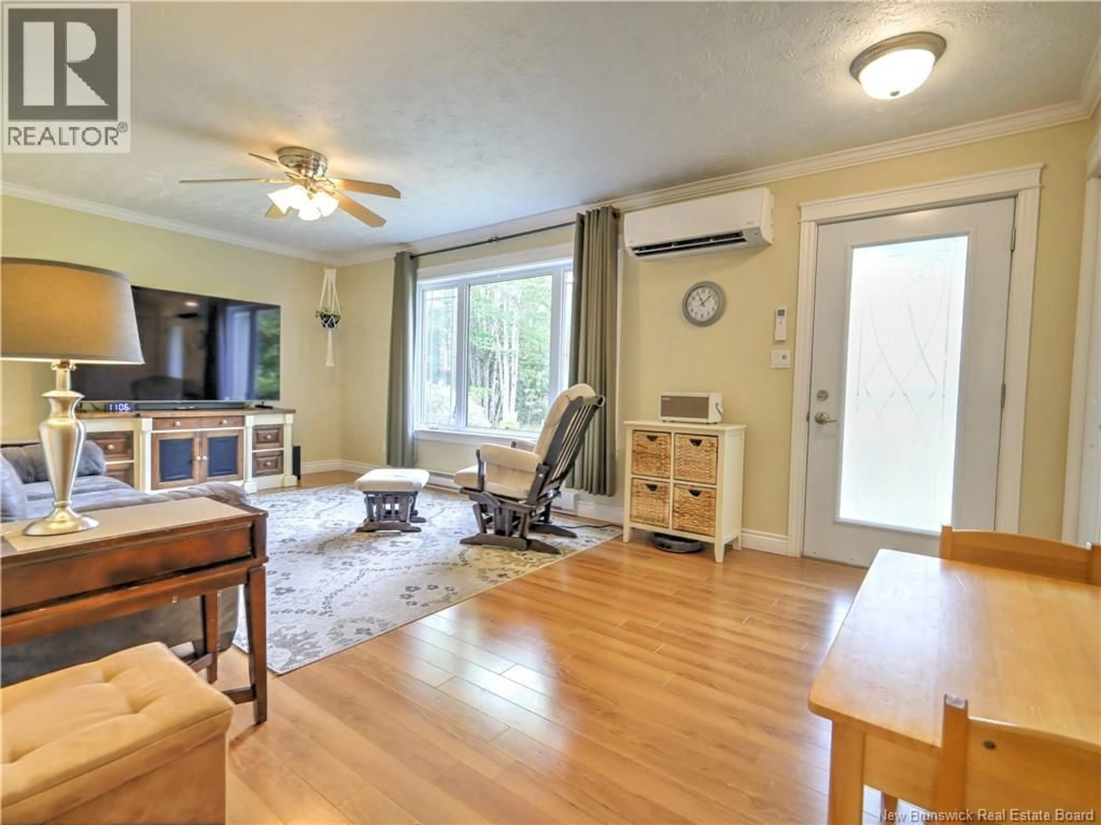 Living room with furniture, wood/laminate floor for 32 MENZIES DRIVE, Hanwell New Brunswick E3C1M6