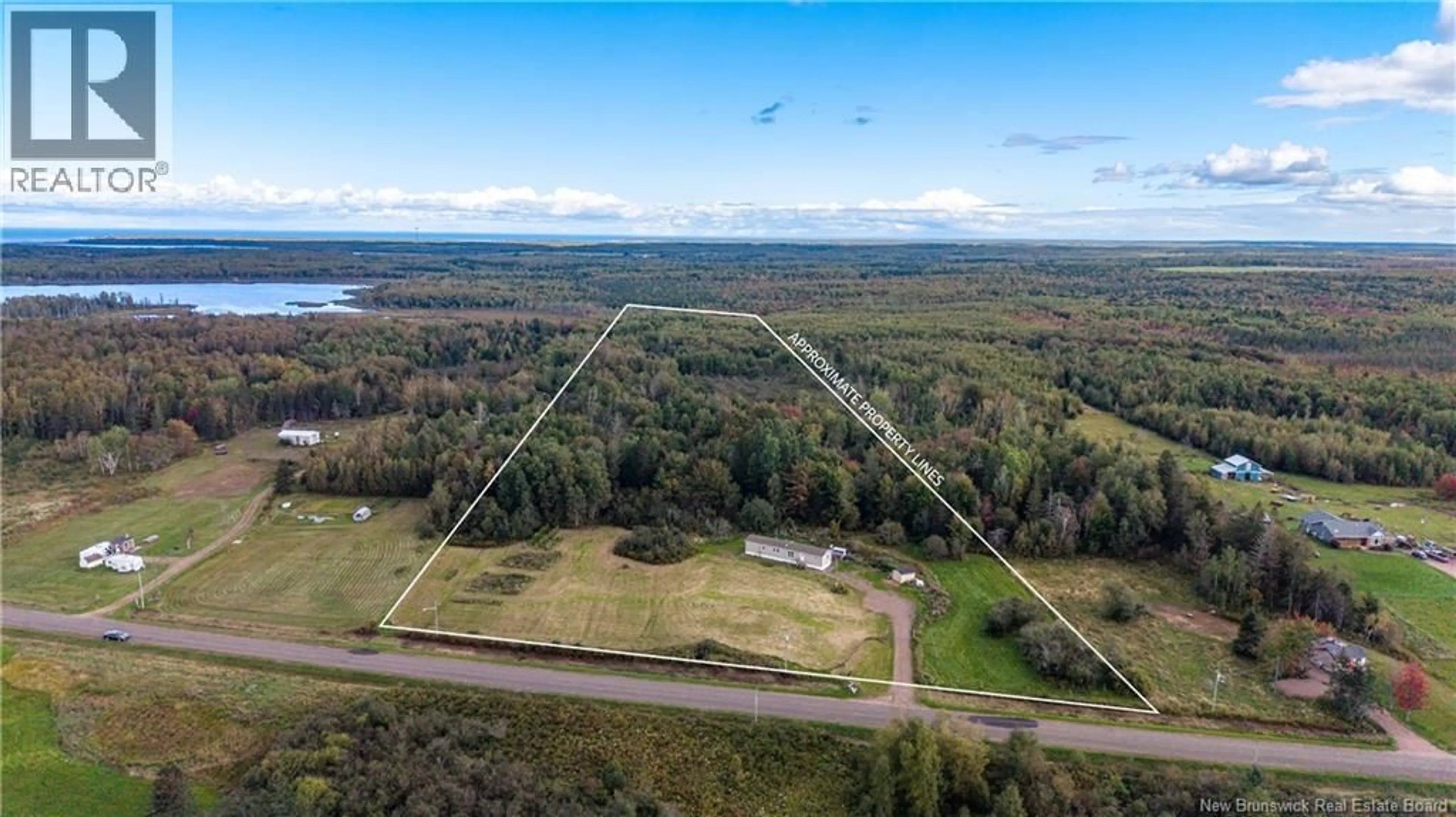 A pic from outside/outdoor area/front of a property/back of a property/a pic from drone, water/lake/river/ocean view for 394 COLLINS LAKE ROAD, Shemogue New Brunswick E4N2N1