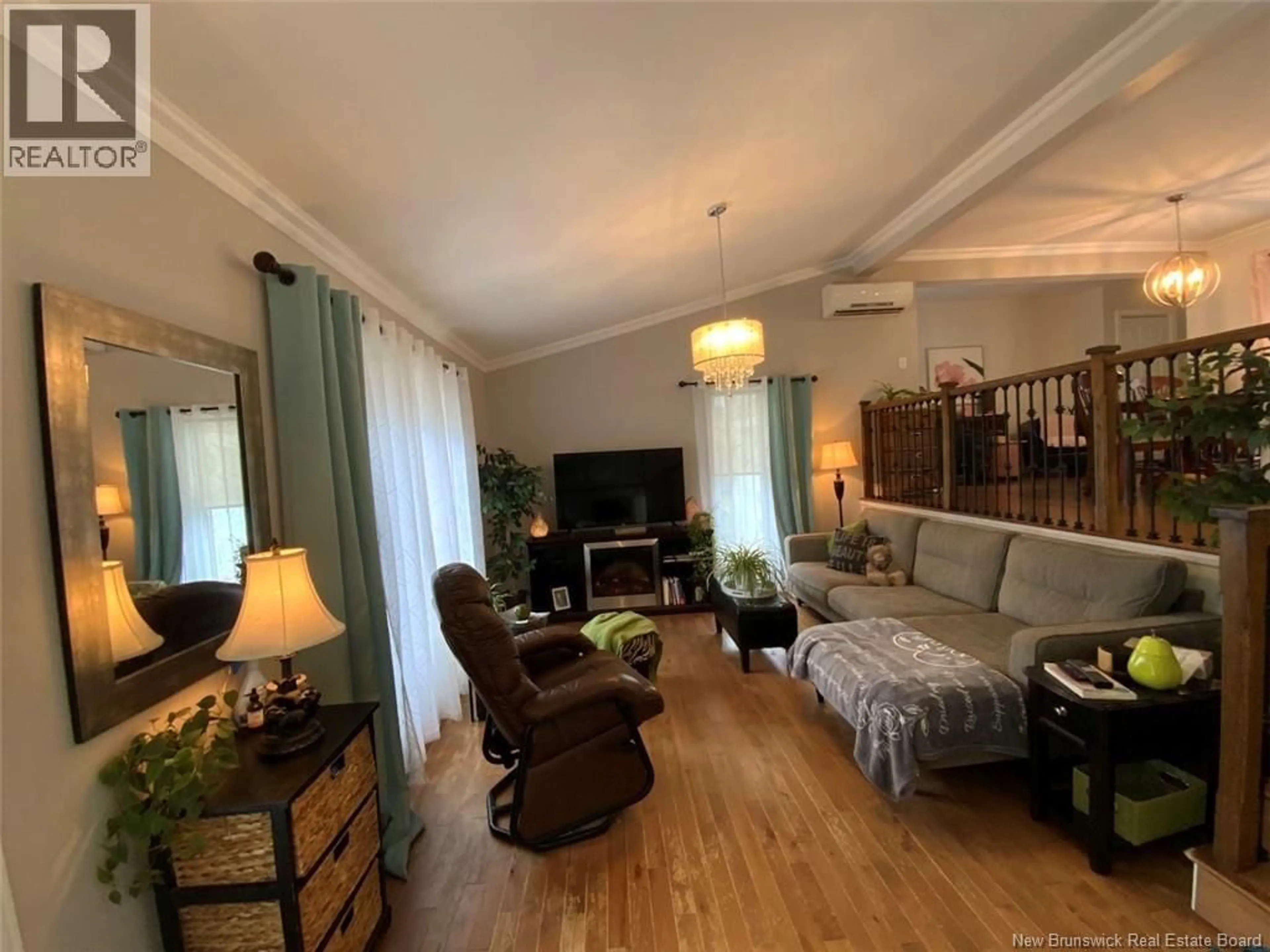 Living room with furniture, wood/laminate floor for 33 BOSSÉ AVENUE, Edmundston New Brunswick E3V3Z8