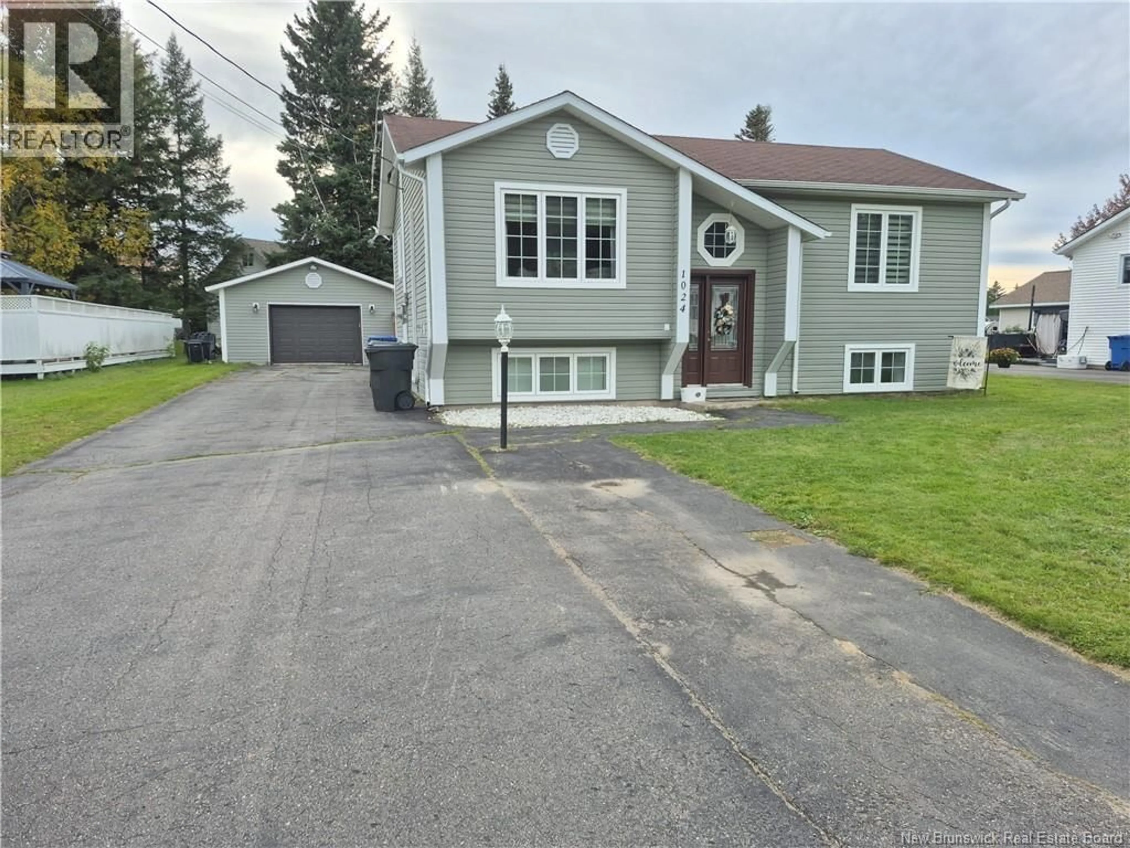 Home with vinyl exterior material, street for 1024 RUE MISHO, Beresford New Brunswick E8K1J4