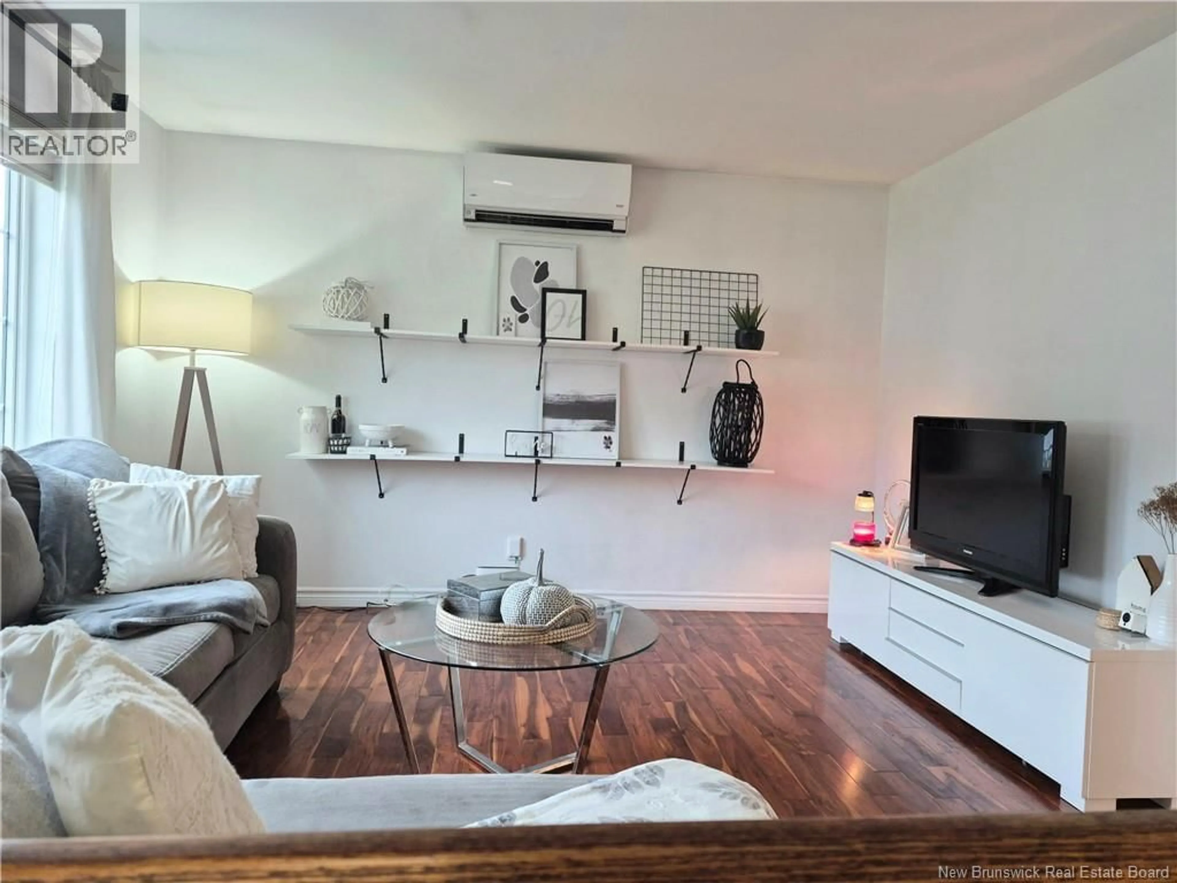 Living room with furniture, wood/laminate floor for 1024 RUE MISHO, Beresford New Brunswick E8K1J4