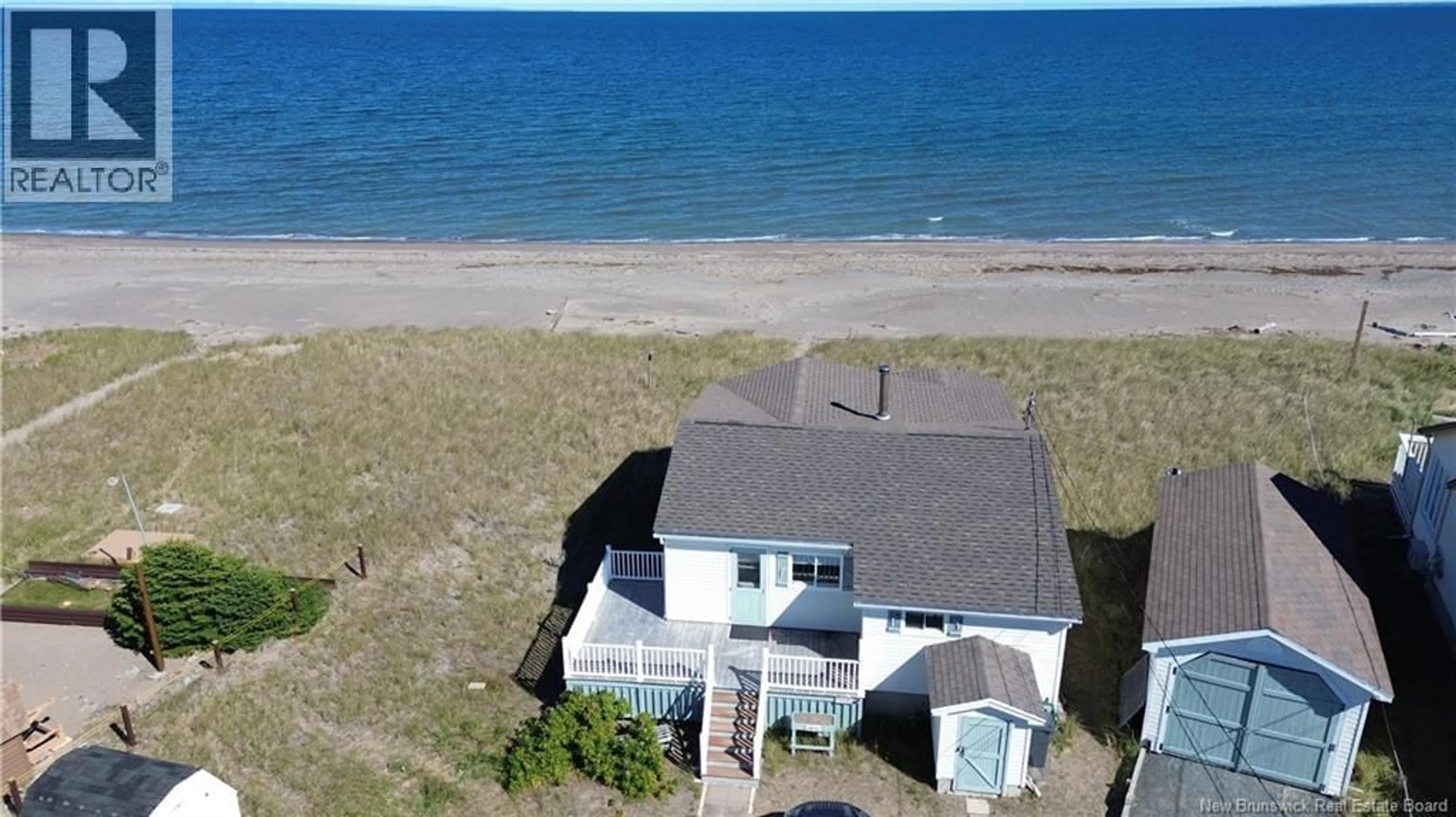 A pic from outside/outdoor area/front of a property/back of a property/a pic from drone, water/lake/river/ocean view for 1011 JOHN CORMIER, Beresford New Brunswick E8K1W3