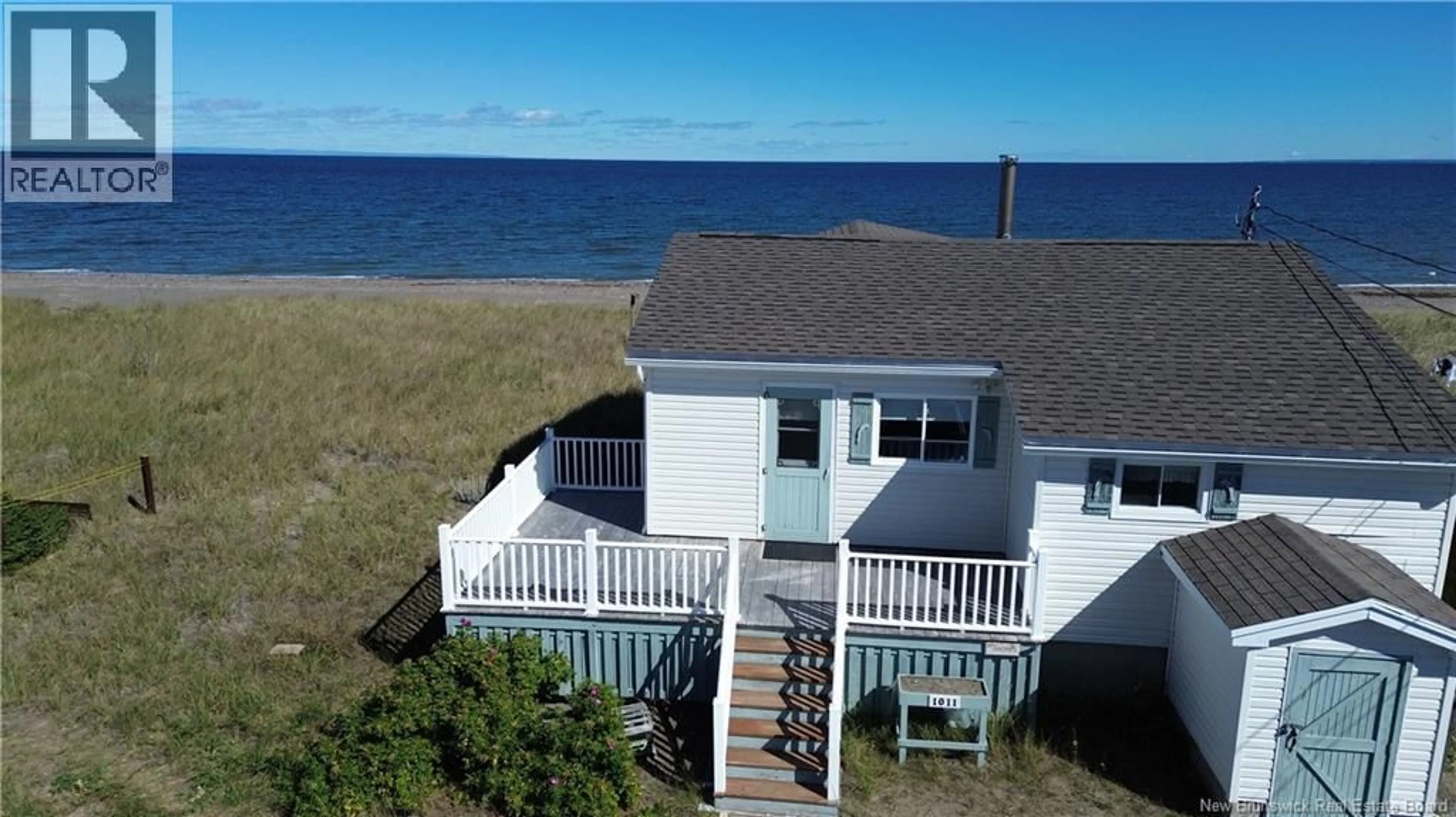 A pic from outside/outdoor area/front of a property/back of a property/a pic from drone, water/lake/river/ocean view for 1011 JOHN CORMIER, Beresford New Brunswick E8K1W3