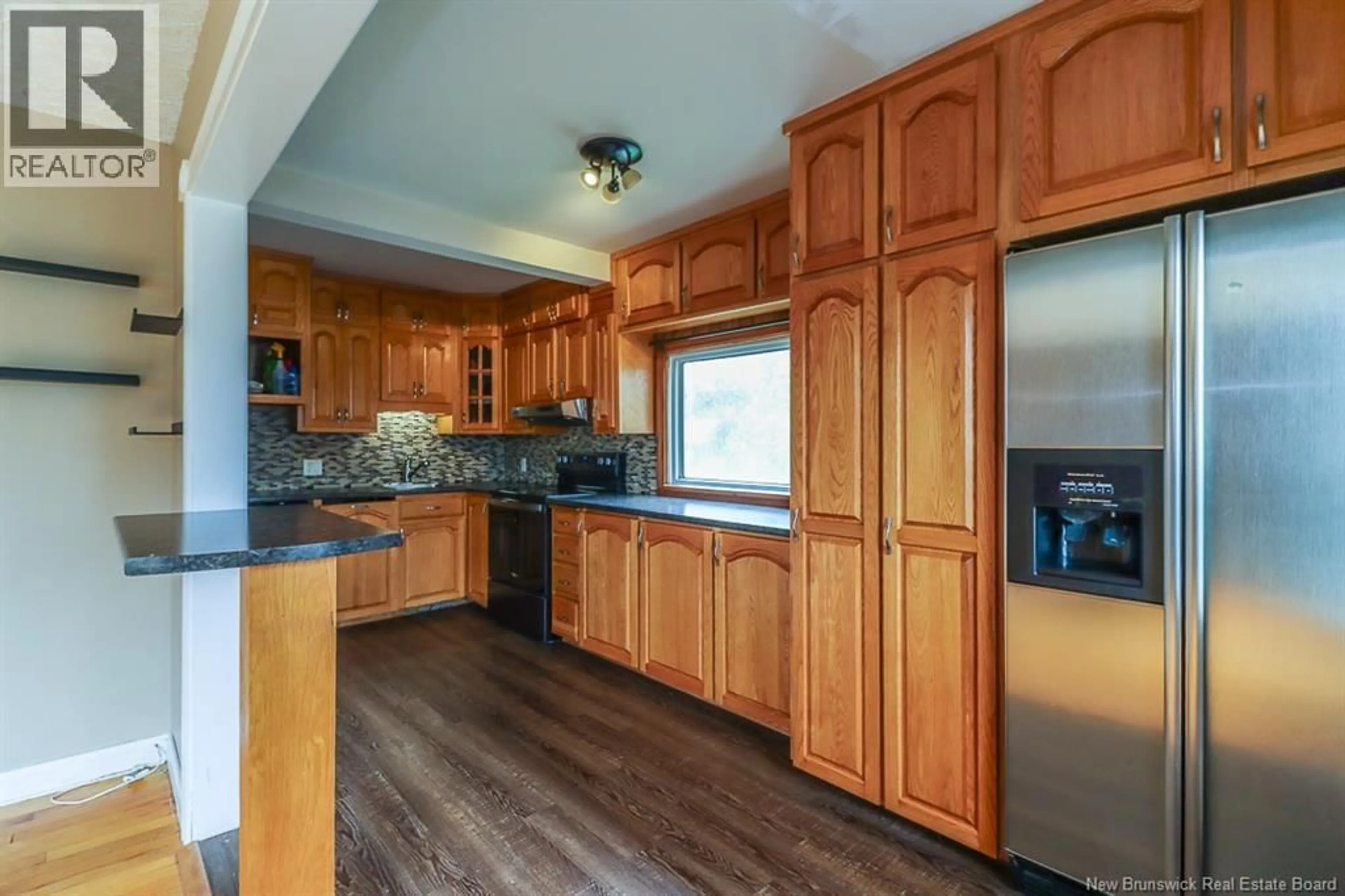Open concept kitchen, wood/laminate floor for 31 KILBURN AVENUE, Saint John New Brunswick E2J2L4