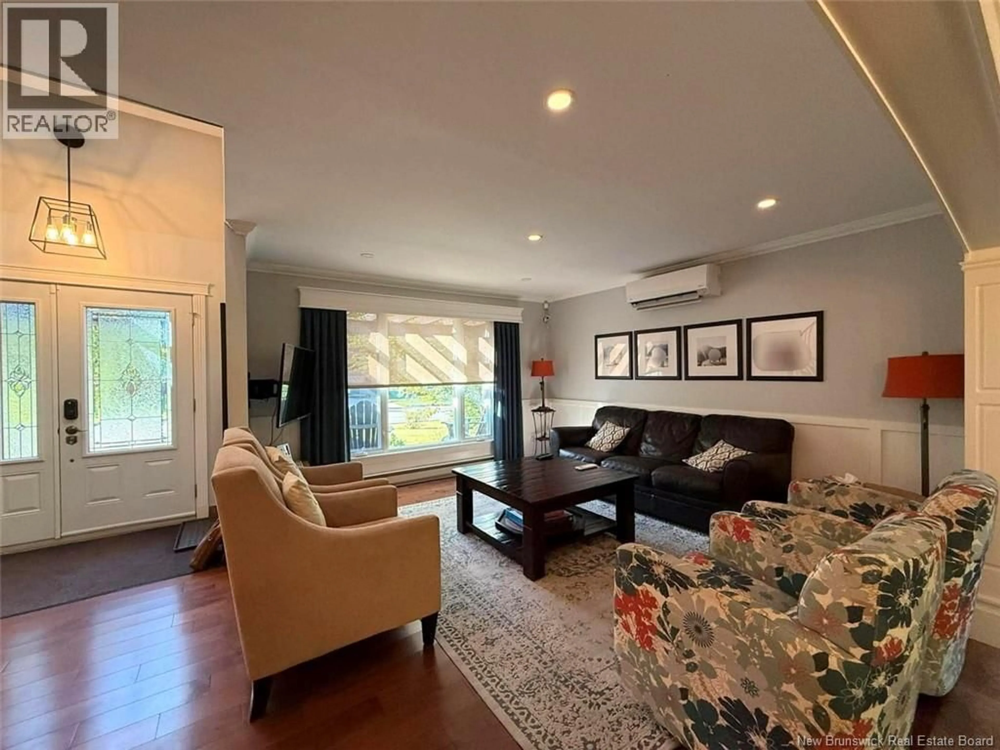 Living room with furniture, wood/laminate floor for 84 HUBERT STREET, Edmundston New Brunswick E3V4K5