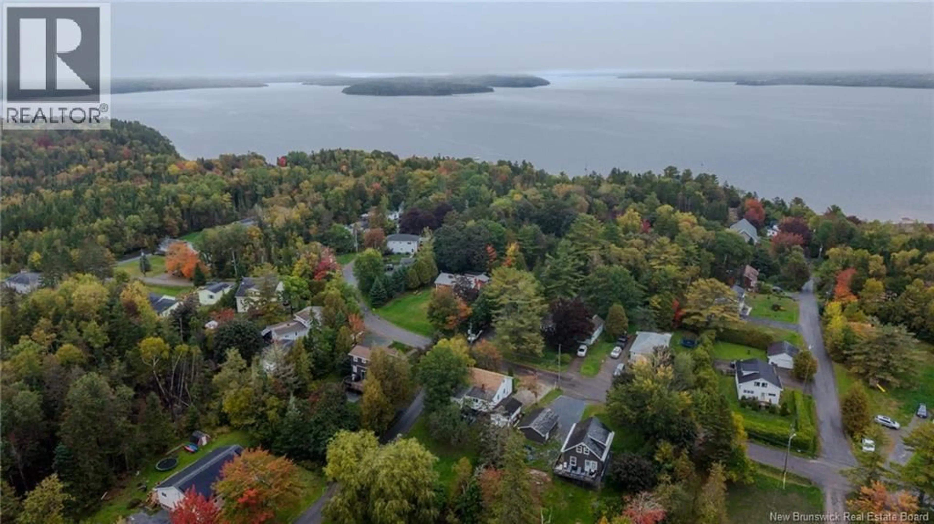 A pic from outside/outdoor area/front of a property/back of a property/a pic from drone, water/lake/river/ocean view for 63 STEVENS ROAD, Saint John New Brunswick E2M6X4