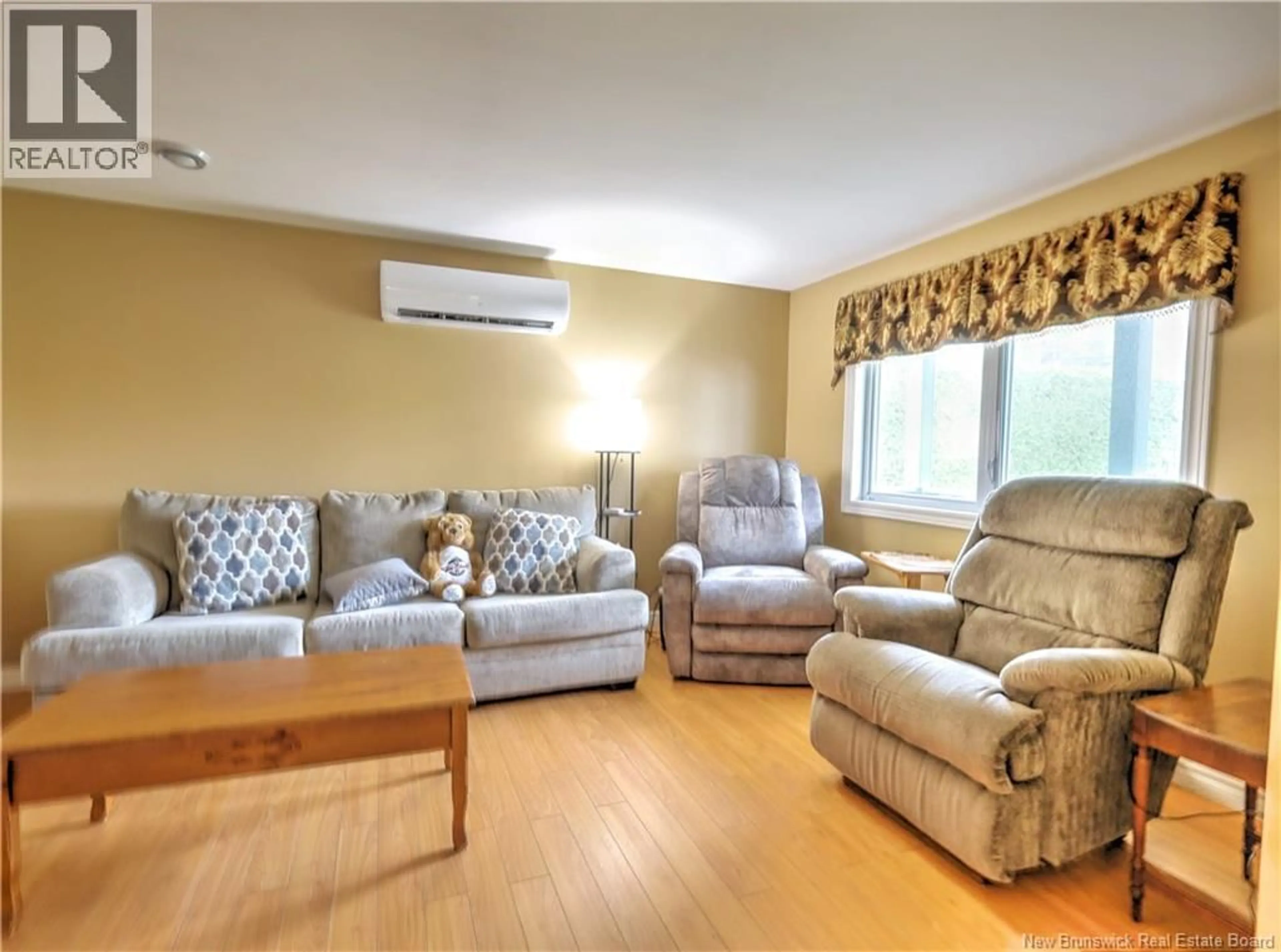 Living room with furniture, wood/laminate floor for 743 WAASIS ROAD, Oromocto New Brunswick E2V2N4