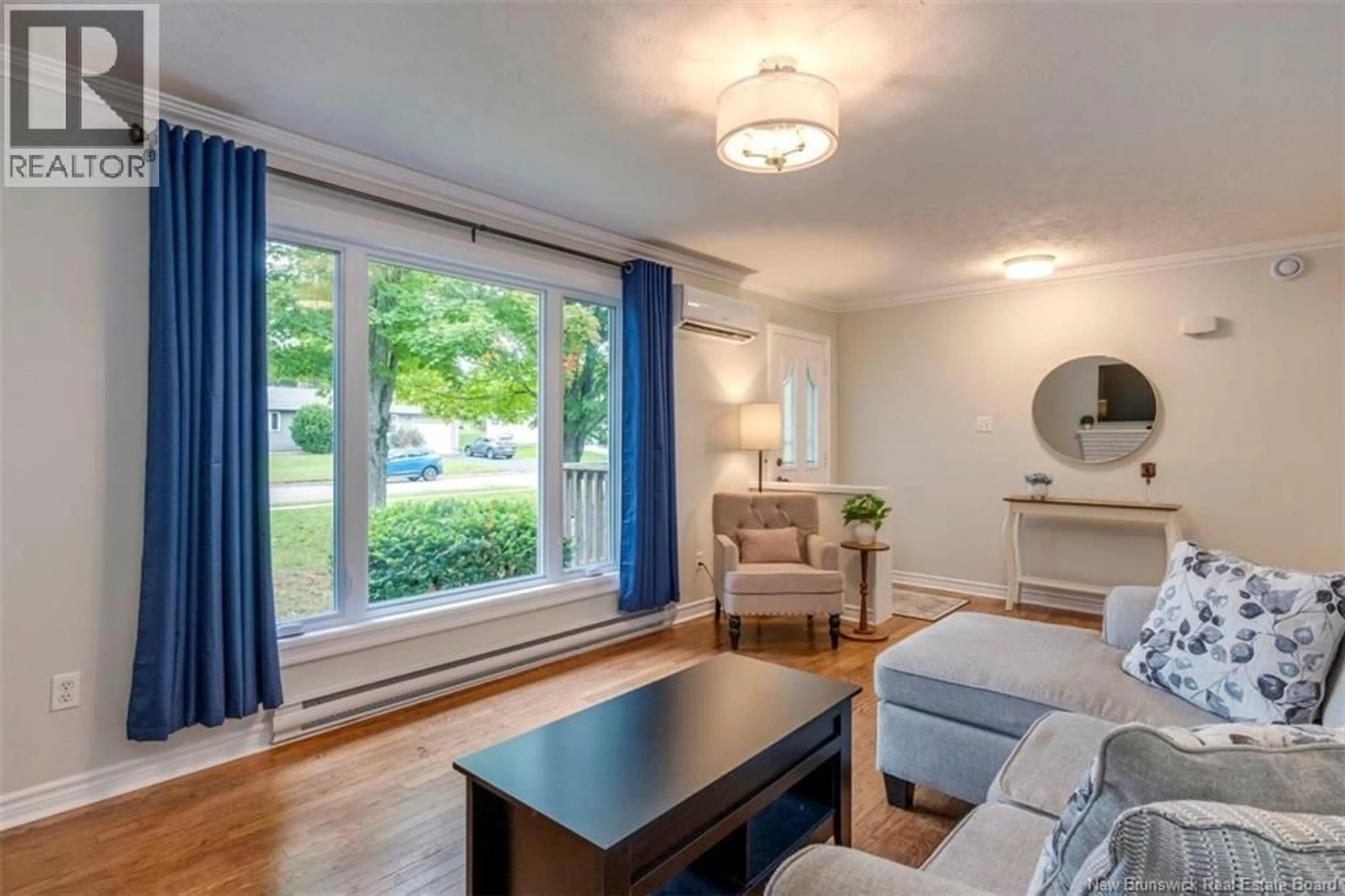 Living room with furniture, wood/laminate floor for 381 BEAUMONT STREET, Dieppe New Brunswick E1A1A7