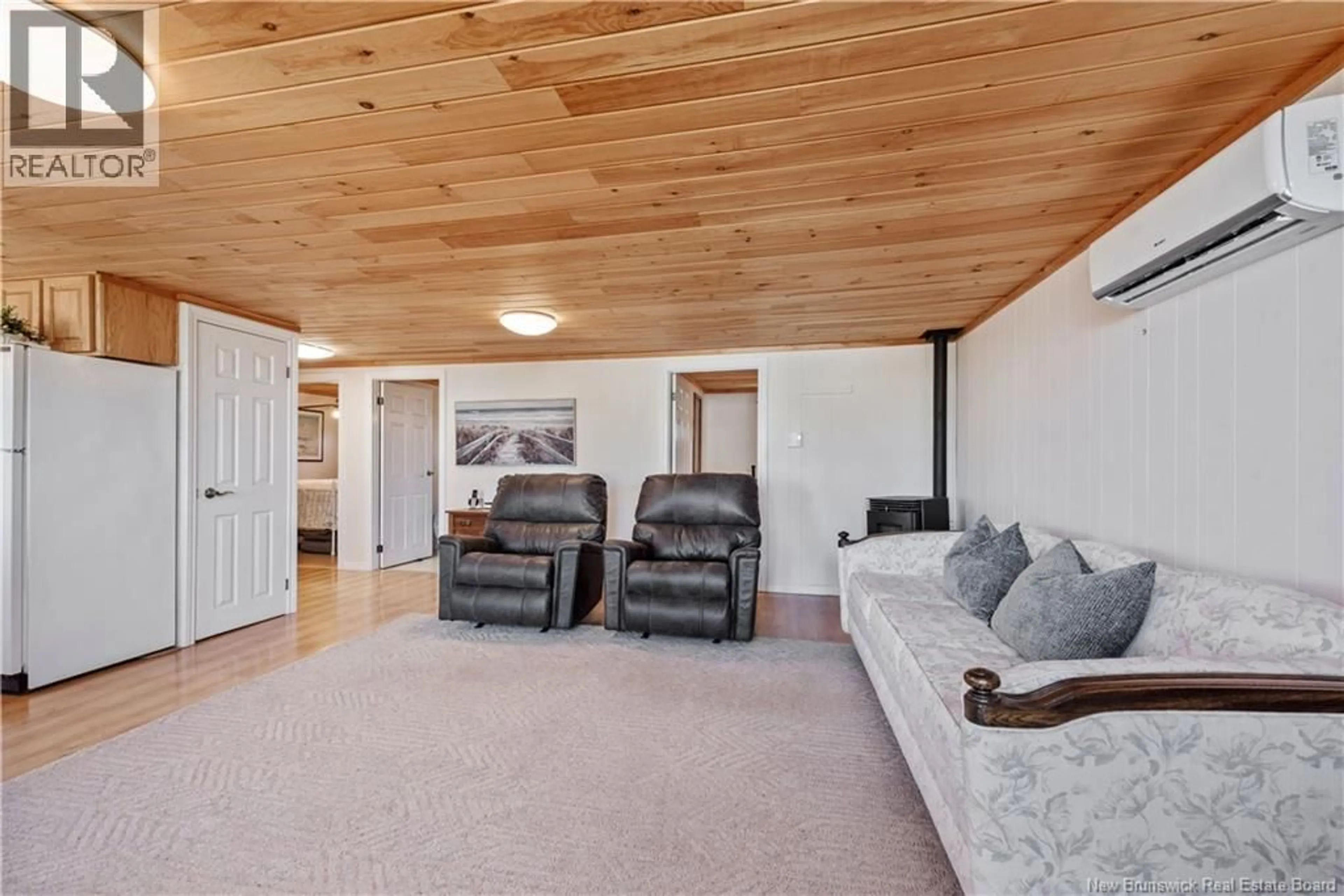 Living room with furniture, wood/laminate floor for 61 BAYBREEZE LANE, Grand-Barachois New Brunswick E4P6W9