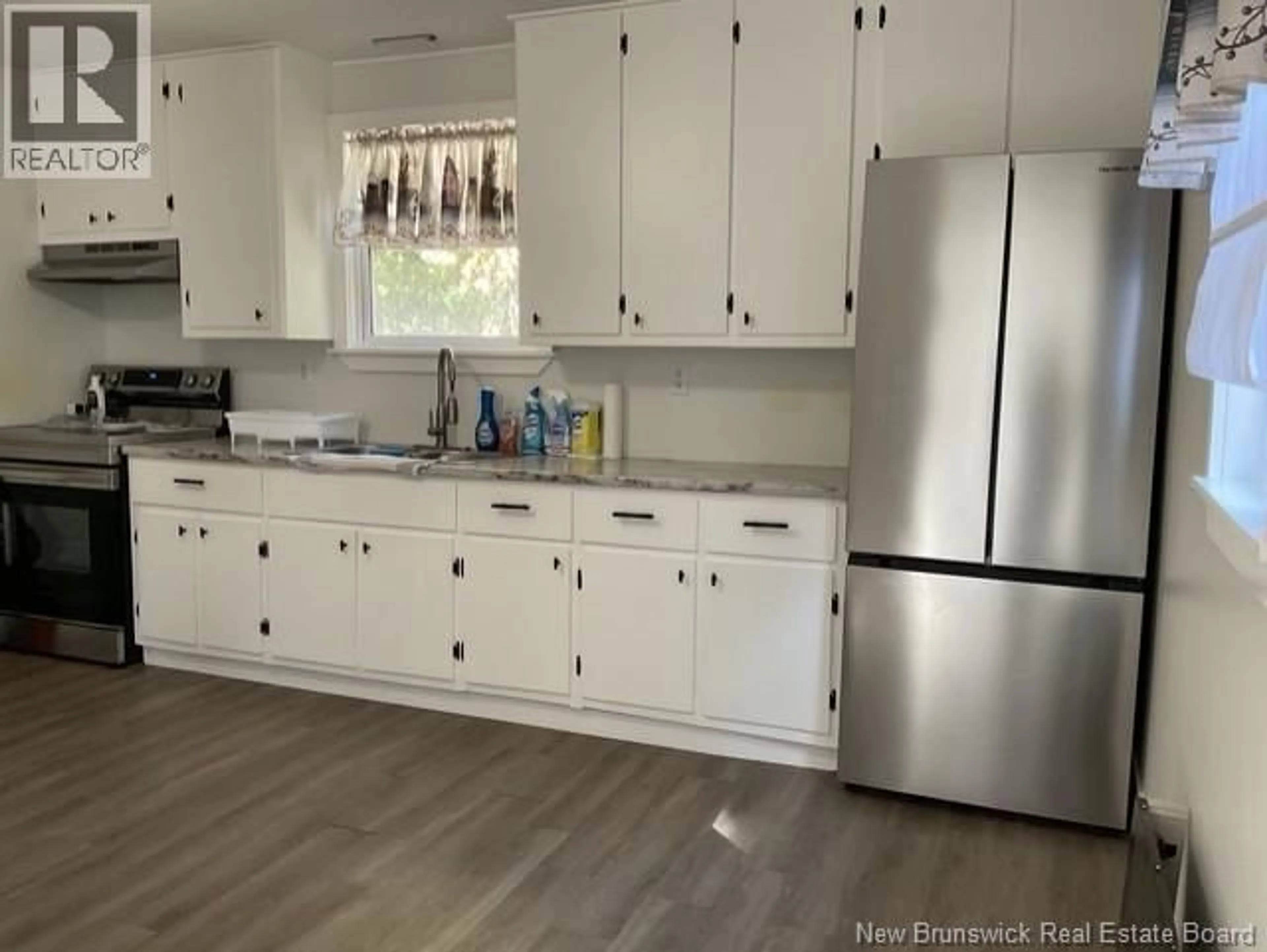 Open concept kitchen, wood/laminate floor for 106 KING STREET, Woodstock New Brunswick E7M2A2