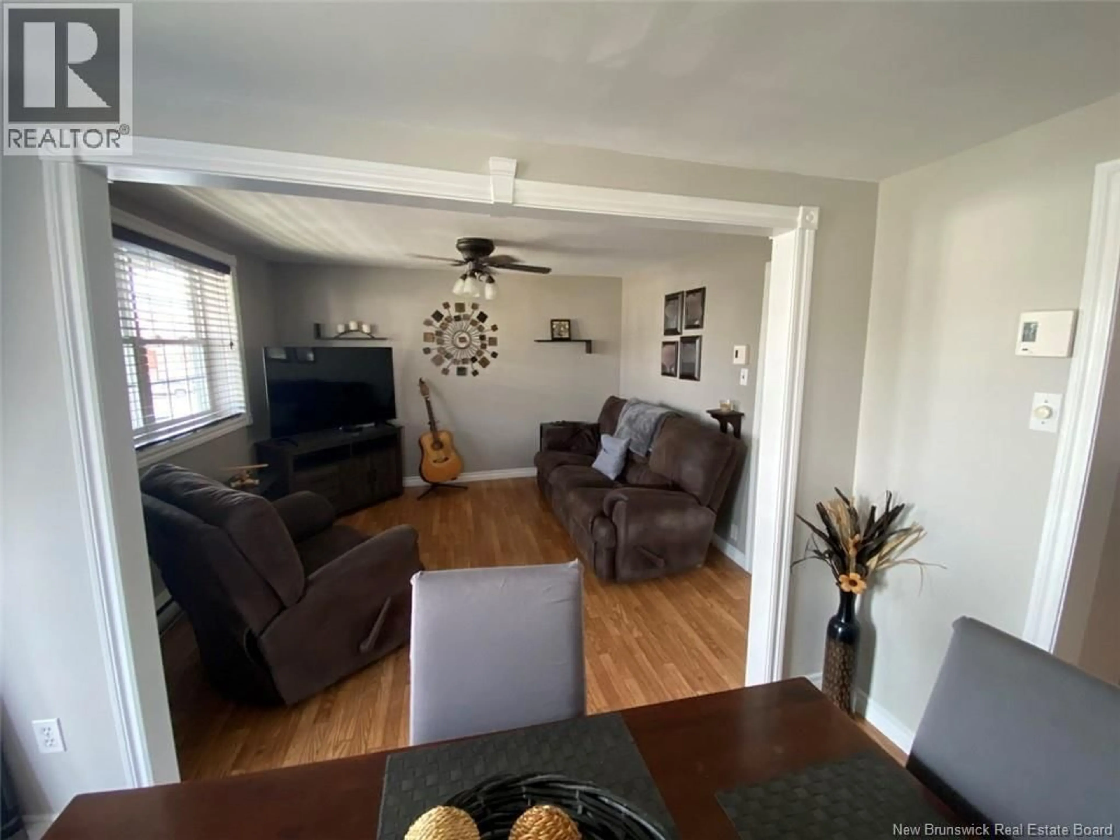 Living room with furniture, wood/laminate floor for 16 46TH AVENUE, Edmundston New Brunswick E3V3B2