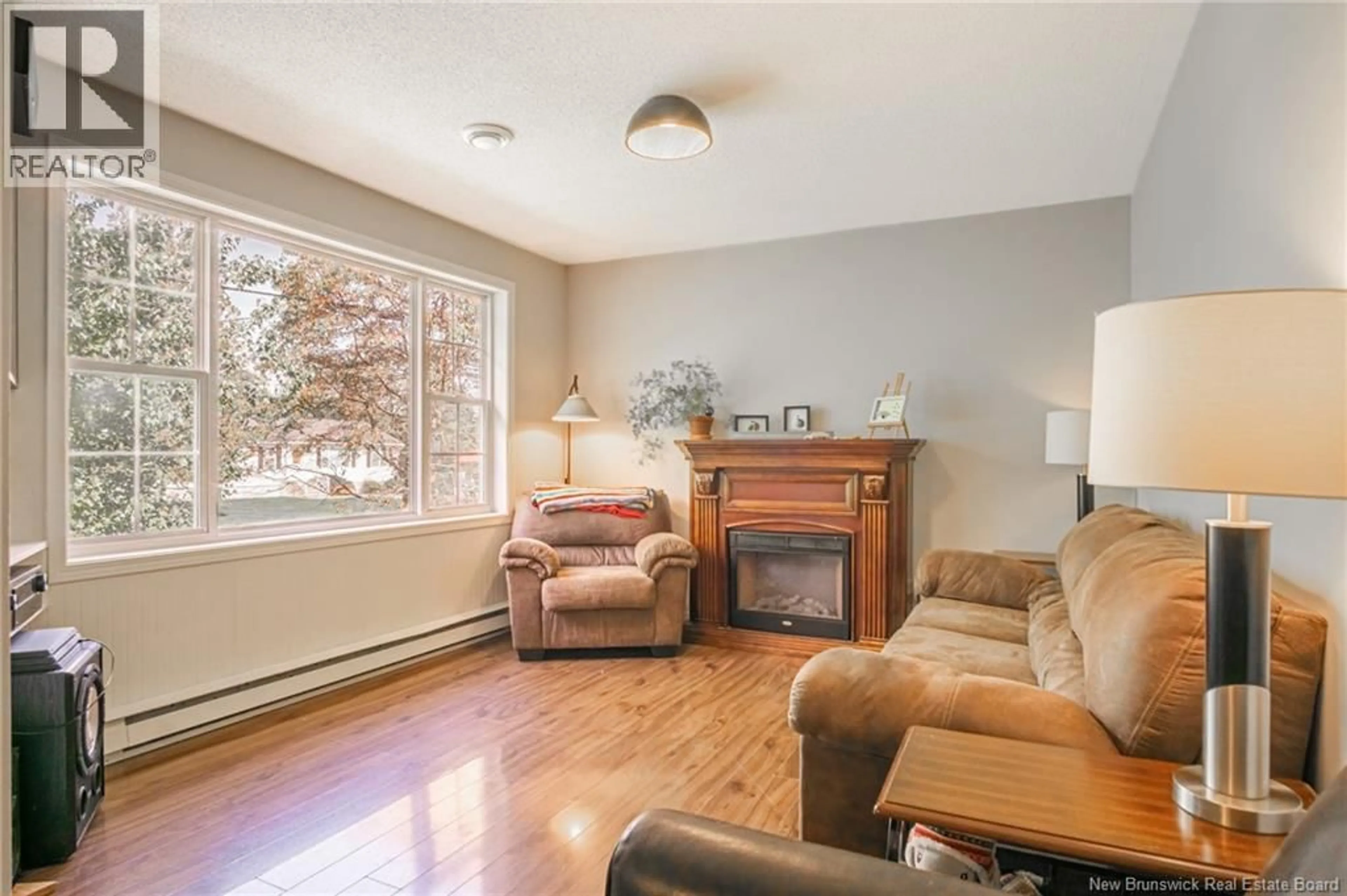 Living room with furniture, wood/laminate floor for 9 DUNN AVENUE, Saint Andrews New Brunswick E5B3V4