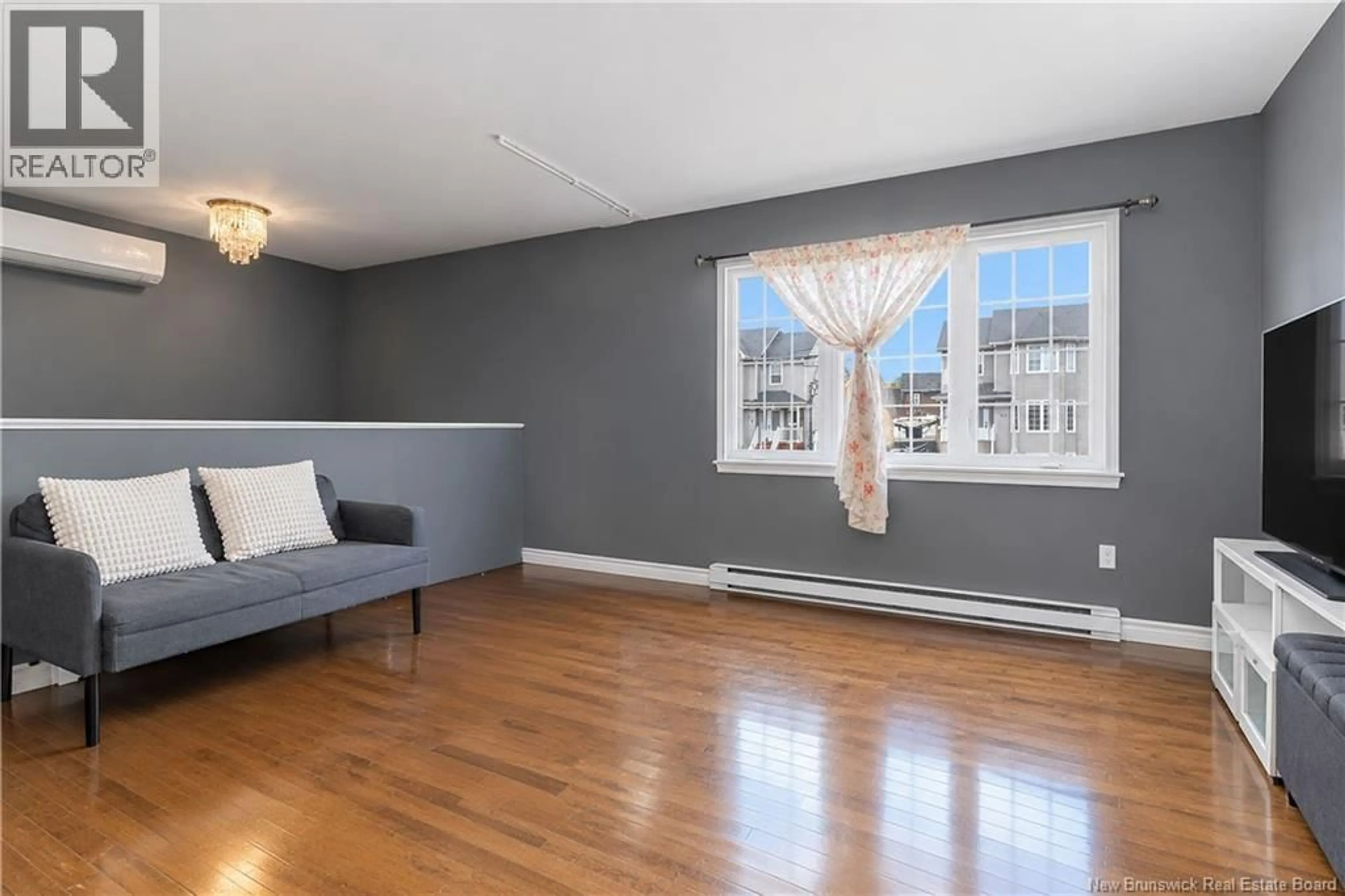 Living room with furniture, wood/laminate floor for 29 BIRCHFIELD STREET, Moncton New Brunswick E1G0W7