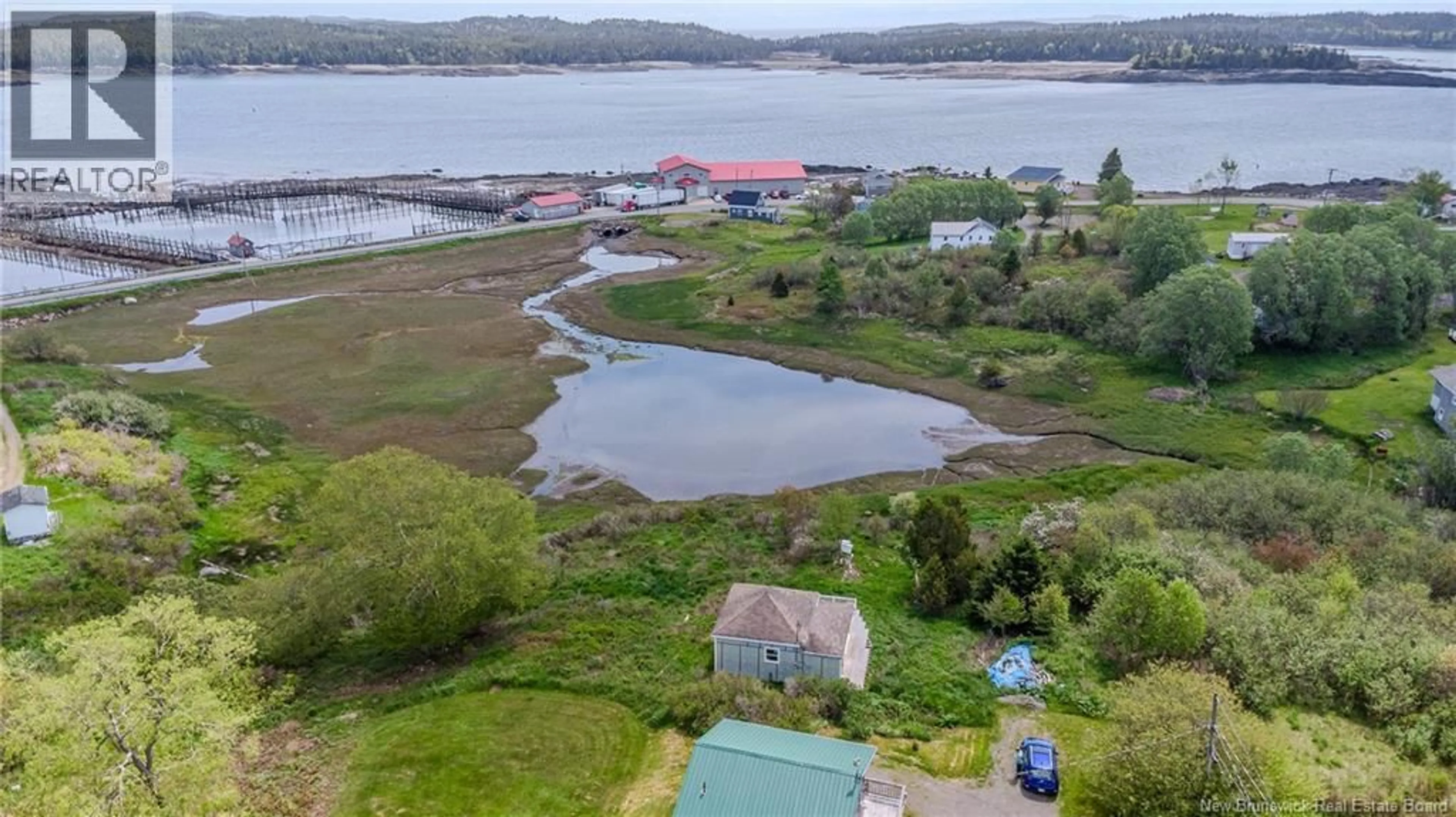 A pic from outside/outdoor area/front of a property/back of a property/a pic from drone, water/lake/river/ocean view for 15 FUNDY VIEW DRIVE, Back Bay New Brunswick E5C2X8