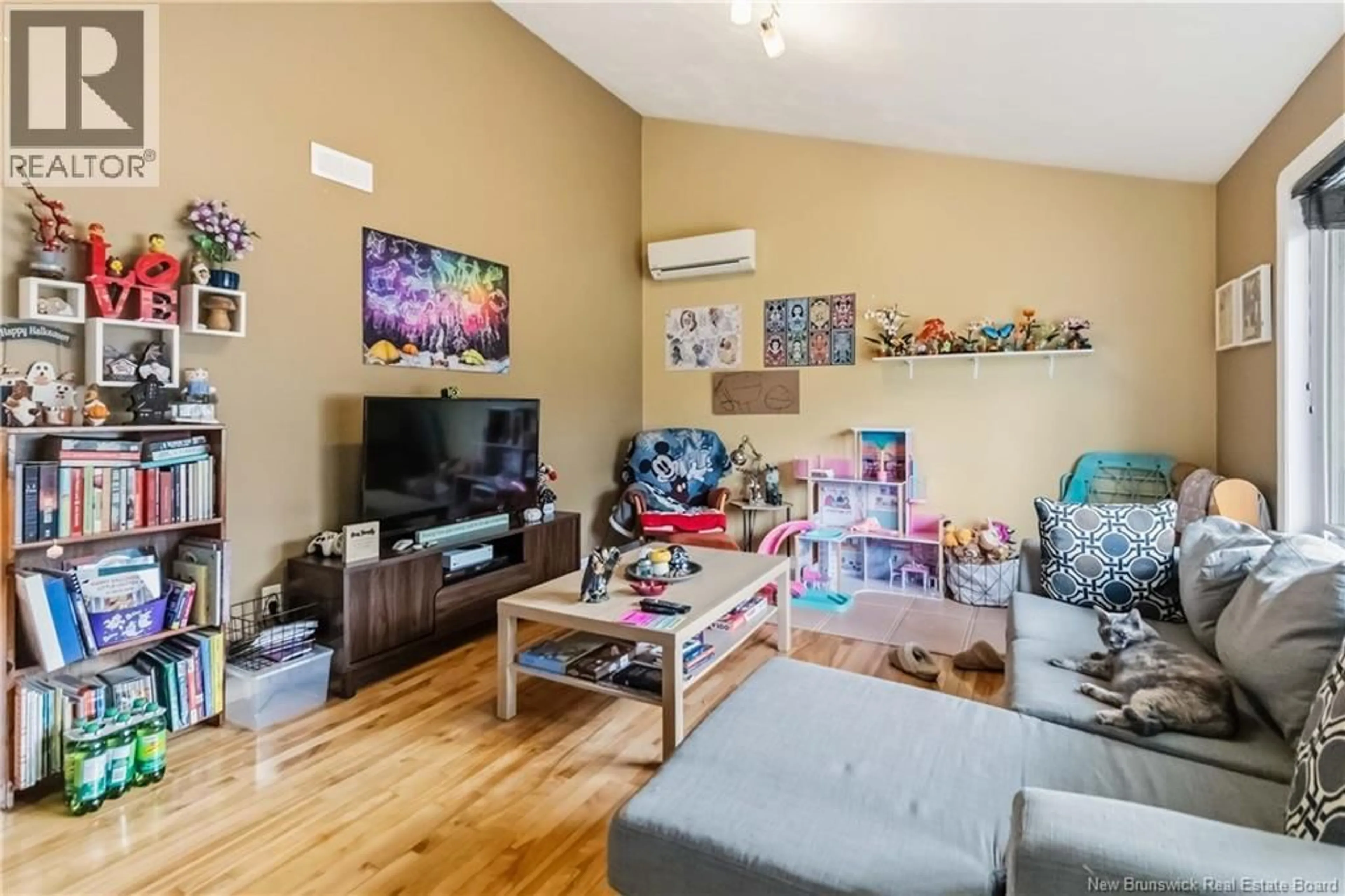 Living room with furniture, wood/laminate floor for 107 RUE CYRIL, Dieppe New Brunswick E1A8R7