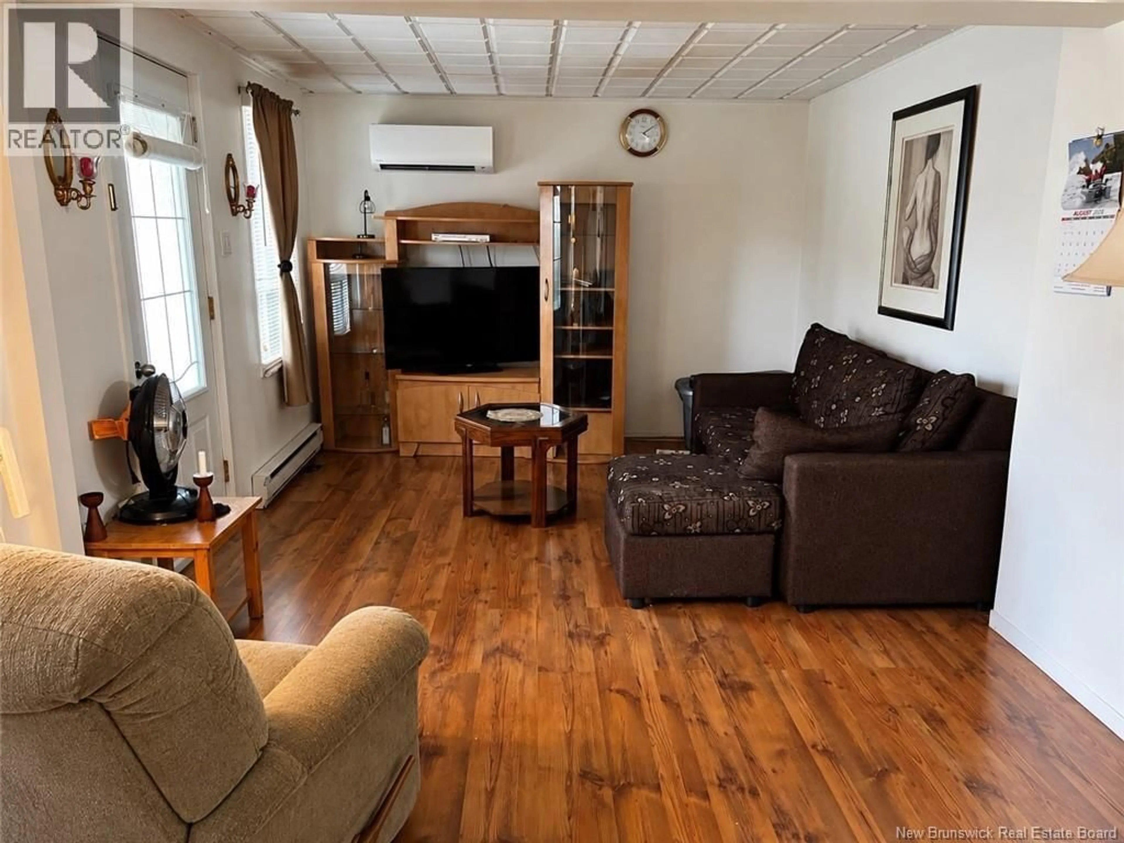 Living room with furniture, wood/laminate floor for 145 ISIDORE BOUCHER, Saint-Jacques New Brunswick E7B1W3