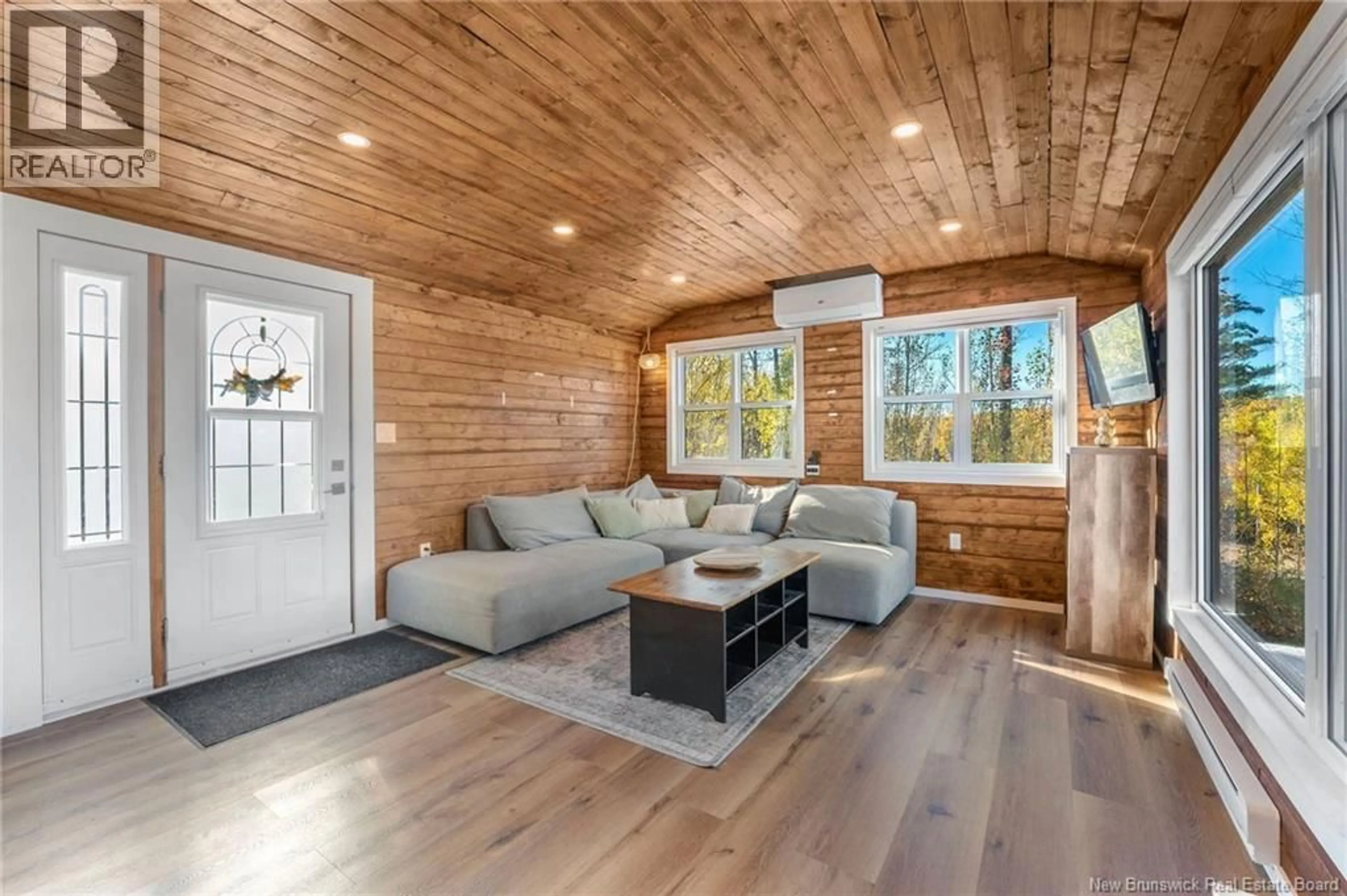 Living room with furniture, wood/laminate floor for 59 BARKER LANE, Longs Creek New Brunswick E6K4B3