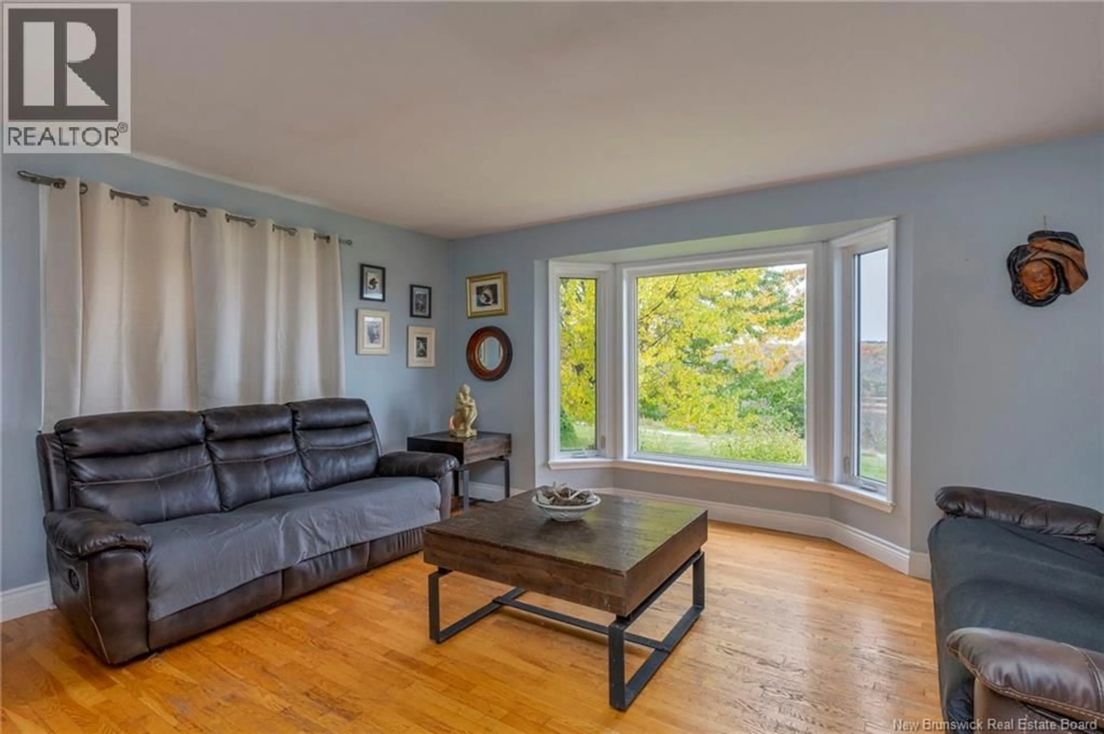 Living room with furniture, wood/laminate floor for 64 NECK ROAD, Quispamsis New Brunswick E2G1J5
