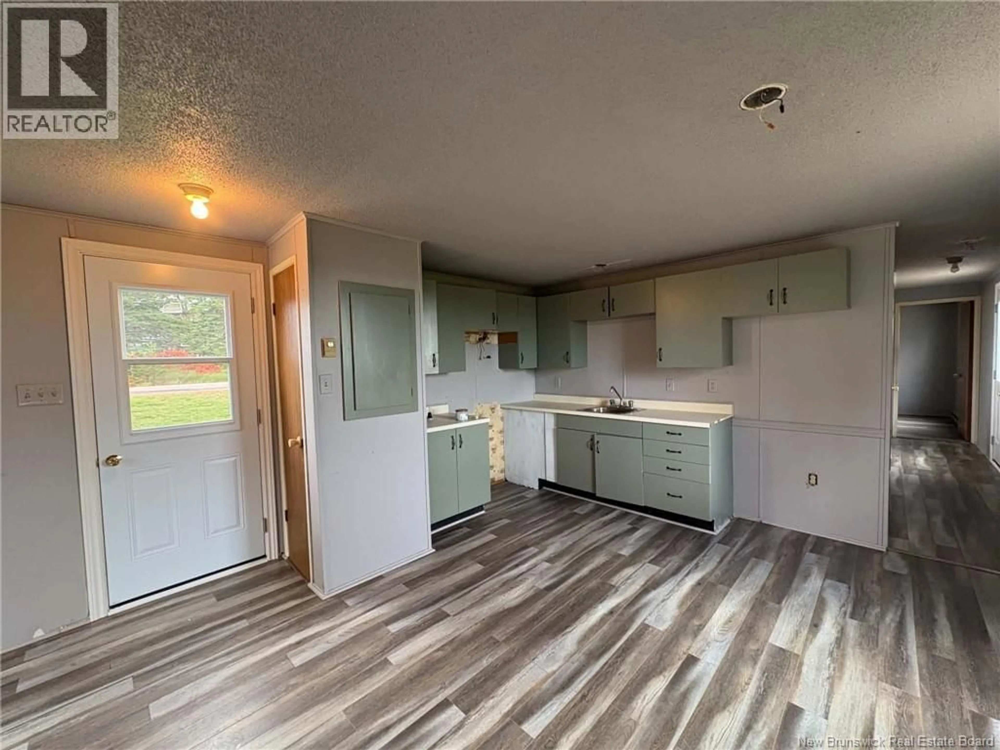 Open concept kitchen, wood/laminate floor for 402 MEMRAMCOOK EST RD, Memramcook East New Brunswick E4K1N6