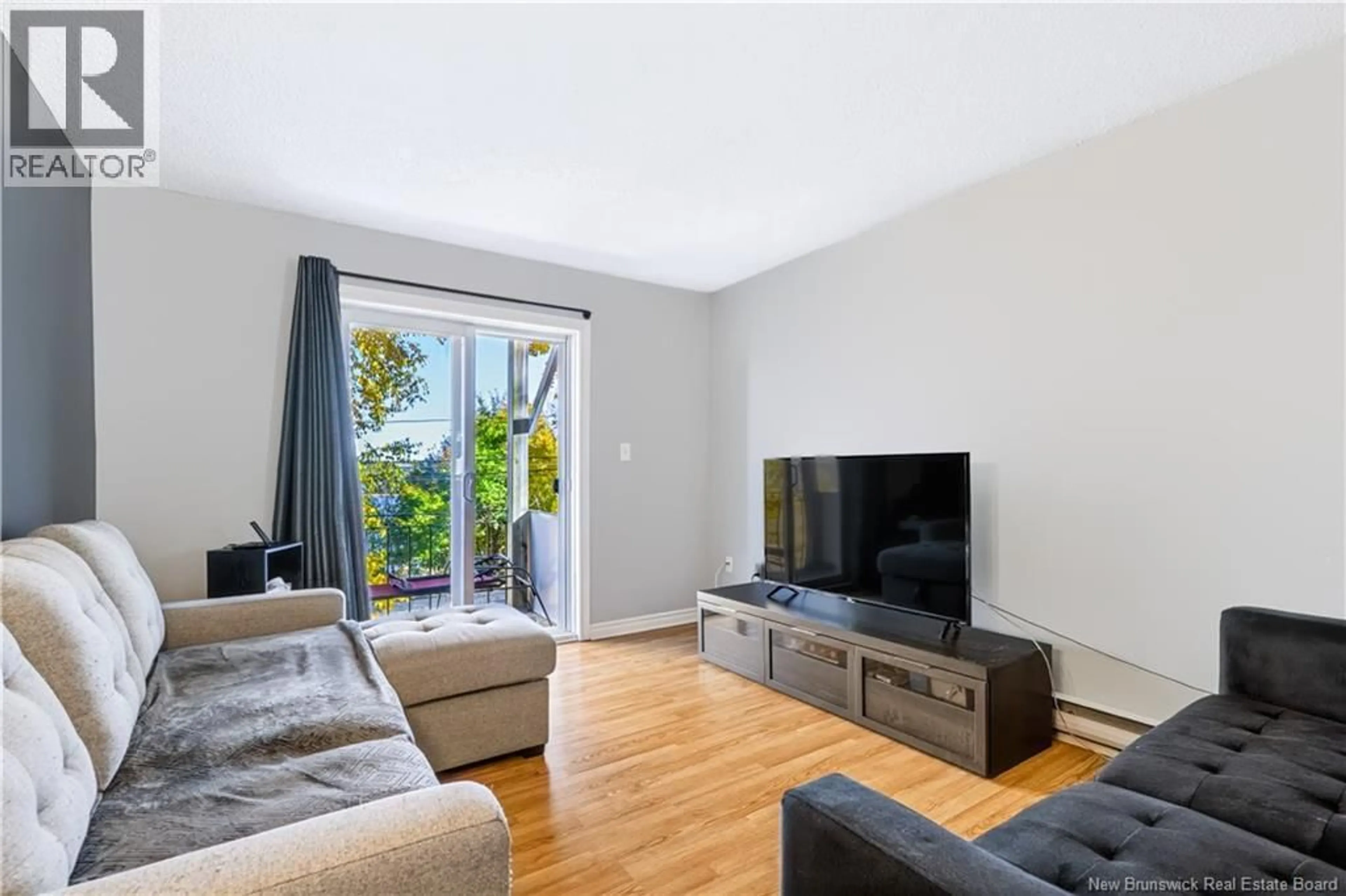 Living room with furniture, wood/laminate floor for 8 - 228 DUNNS CROSSING ROAD, Fredericton New Brunswick E3A2A6