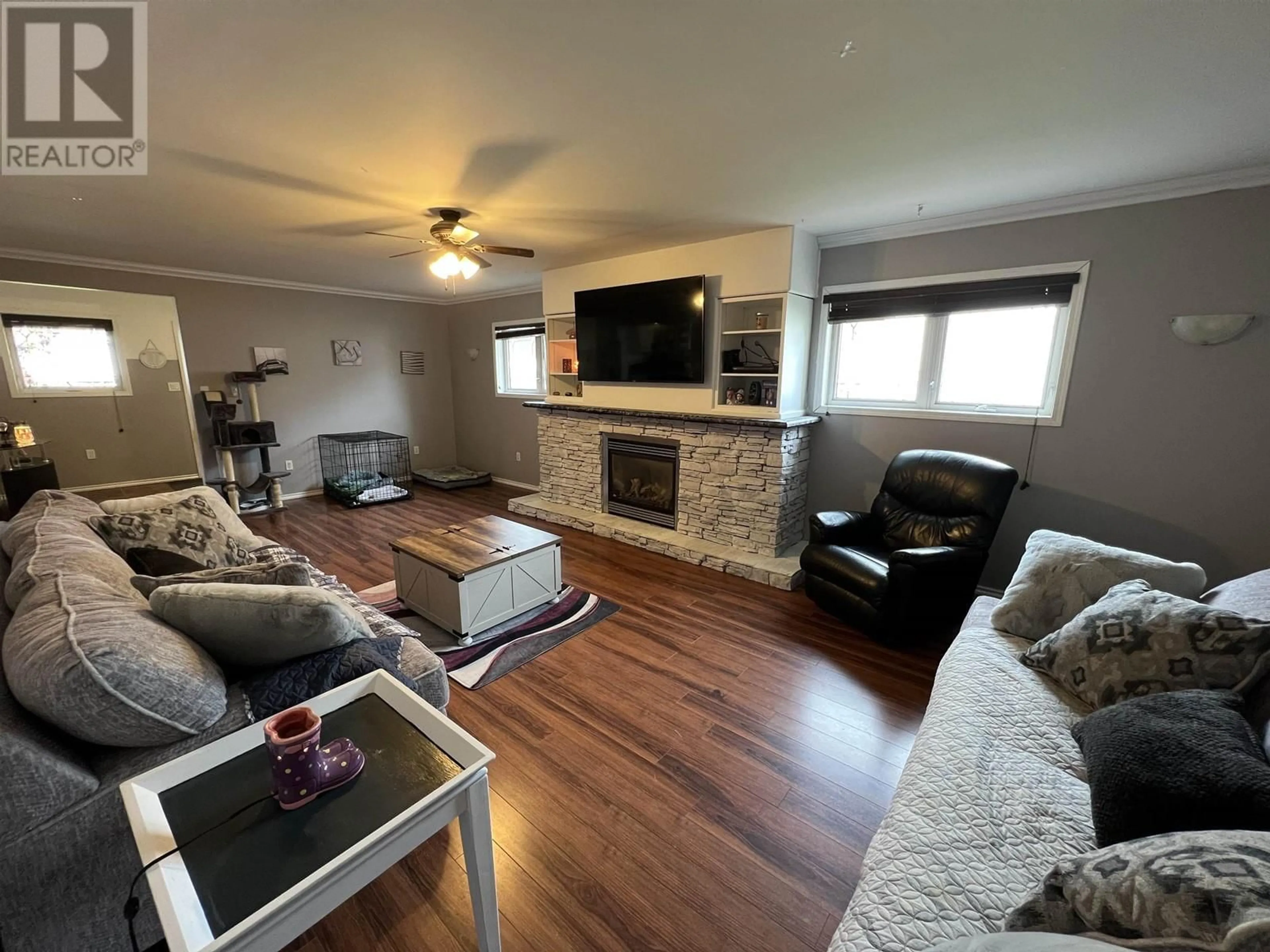 Living room with furniture, wood/laminate floor for 5228 40 STREET, Fort Nelson British Columbia V0C1R0