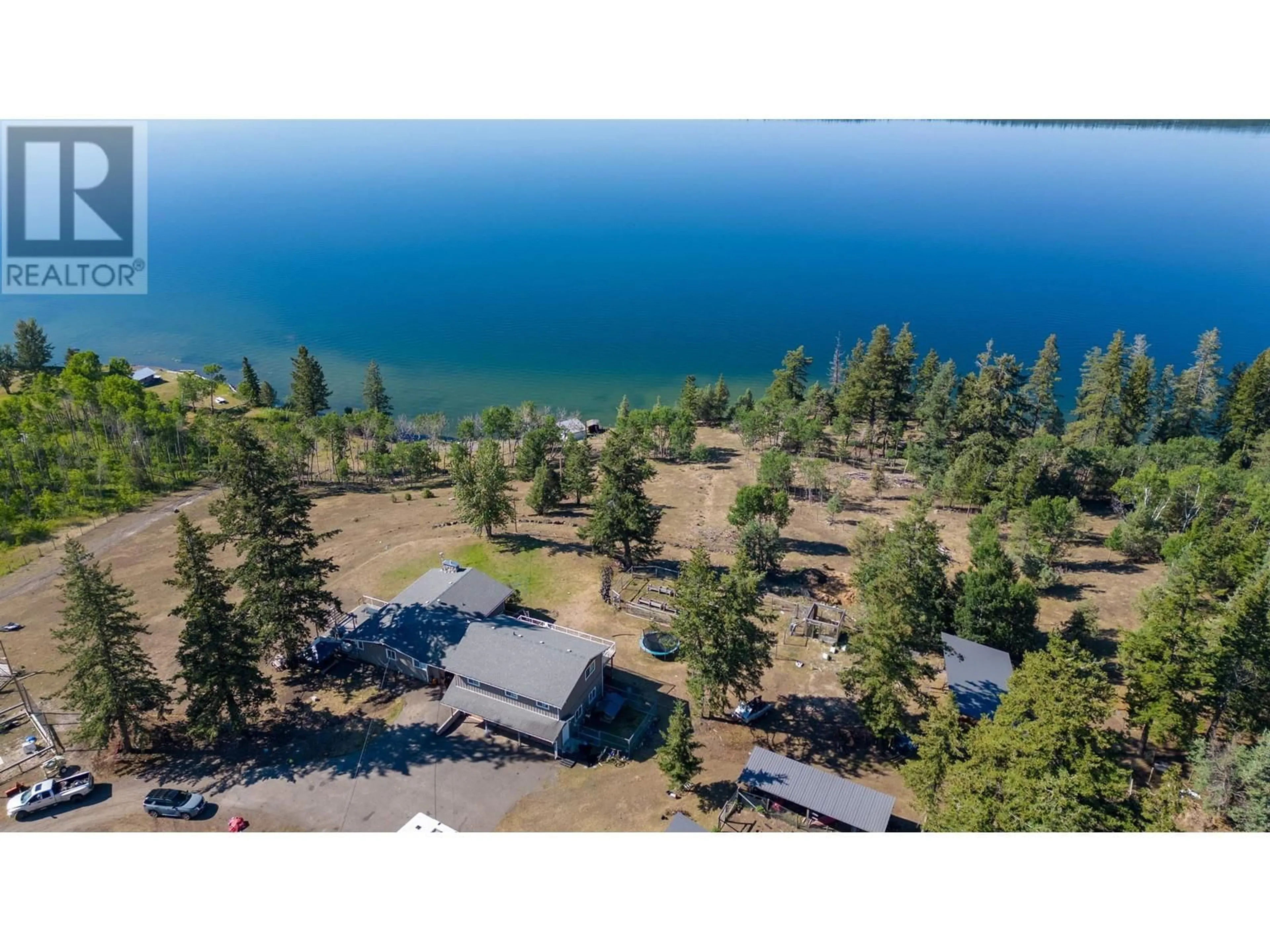 A pic from outside/outdoor area/front of a property/back of a property/a pic from drone, water/lake/river/ocean view for 3920 TROUT DRIVE, Lac La Hache British Columbia V0K1T0