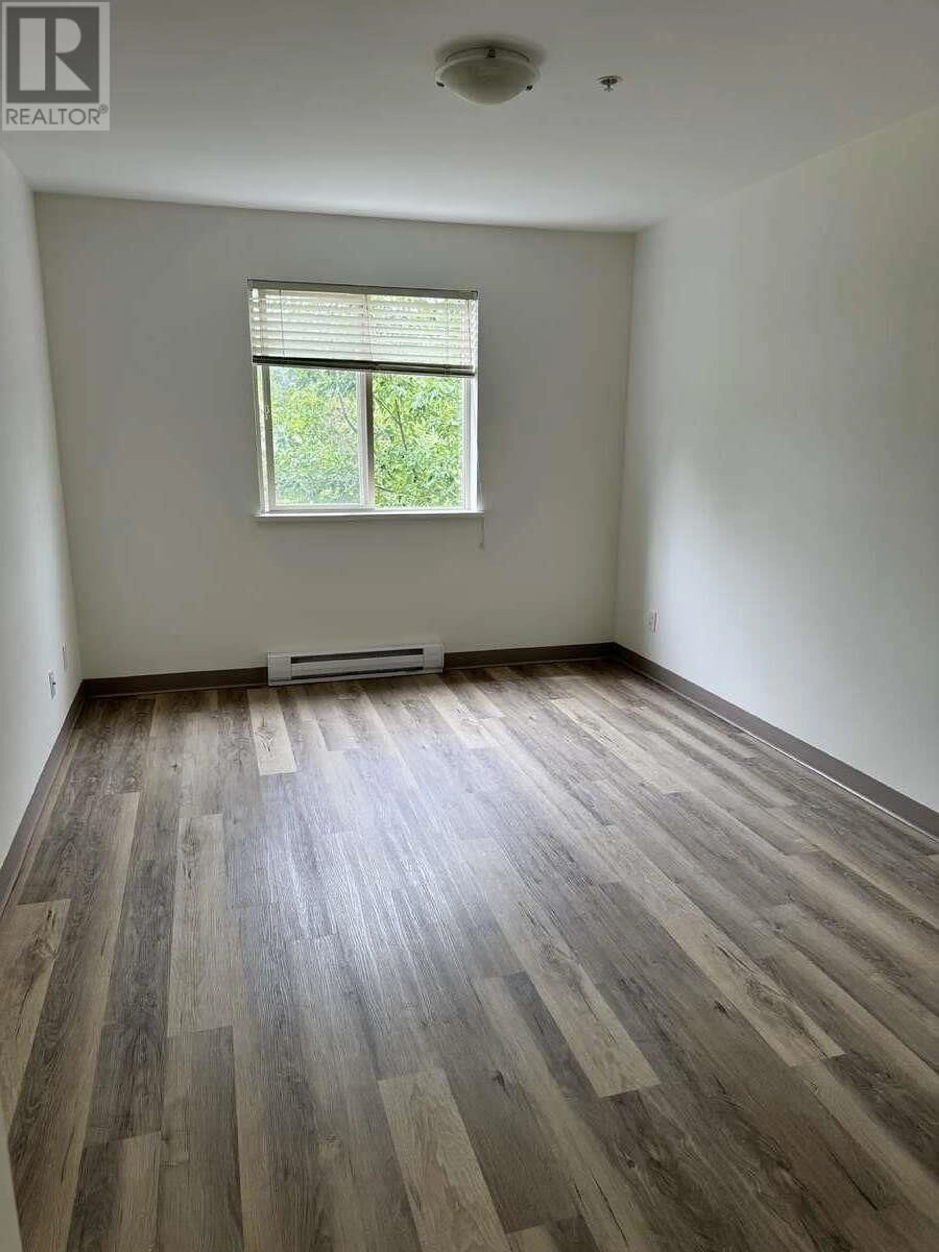 A pic of a room, wood floors for 207 5631 INLET AVENUE, Sechelt British Columbia V7Z0J1