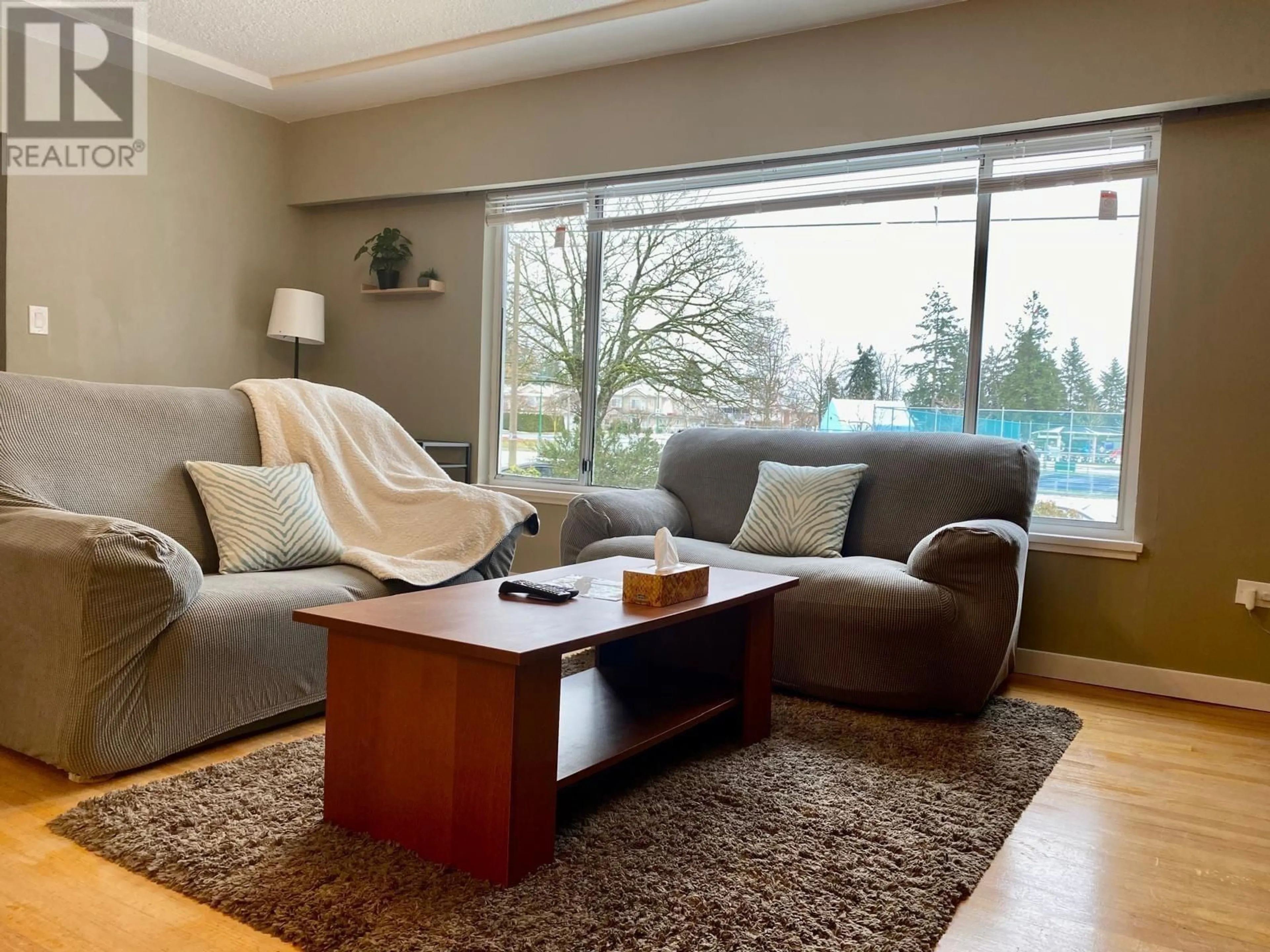 Living room with furniture, wood/laminate floor for 7433 ELWELL STREET, Burnaby British Columbia V5E1L3