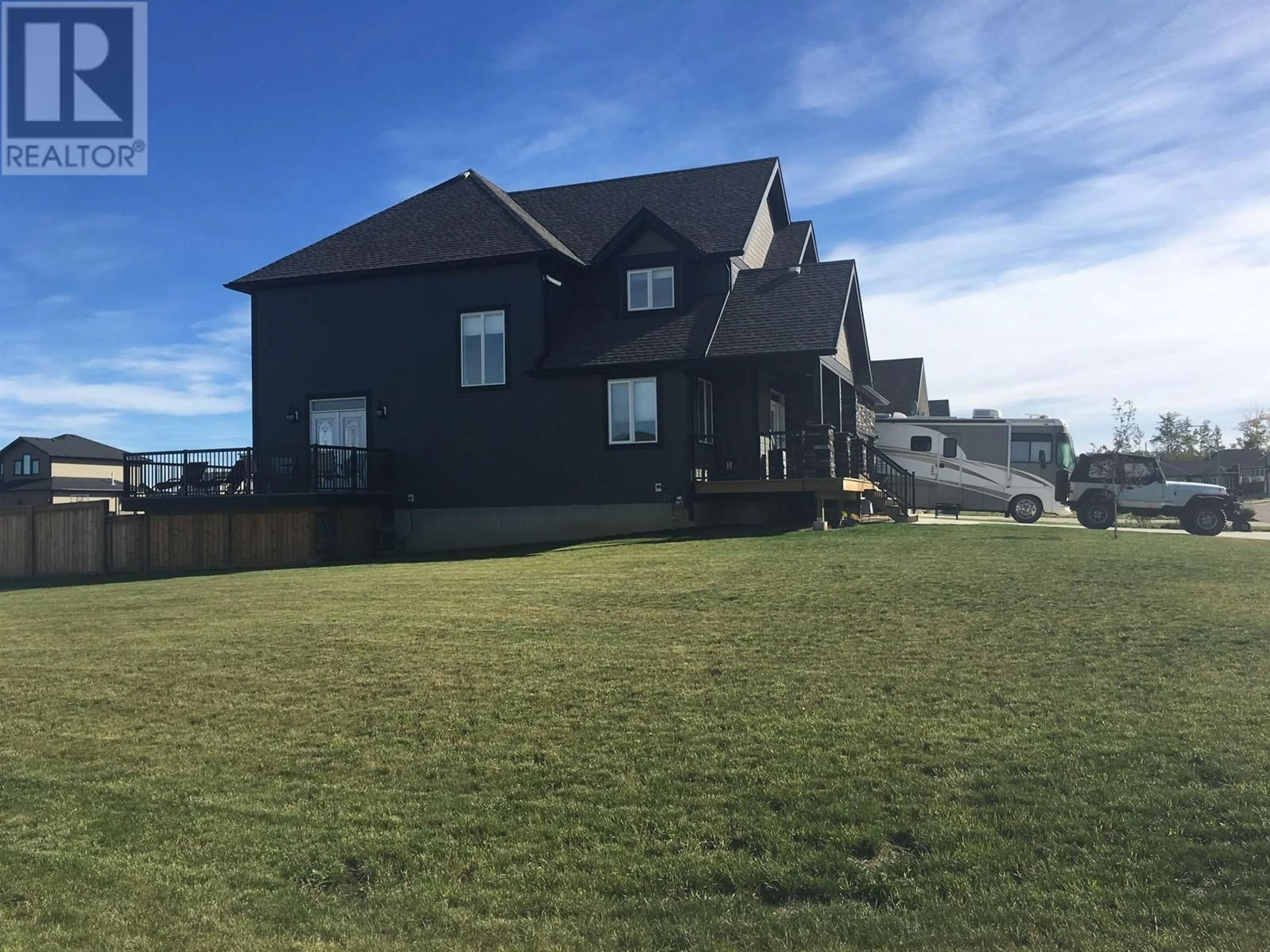 Frontside or backside of a home, the fenced backyard for 10928 110 AVENUE, Fort St. John British Columbia V1J0J7