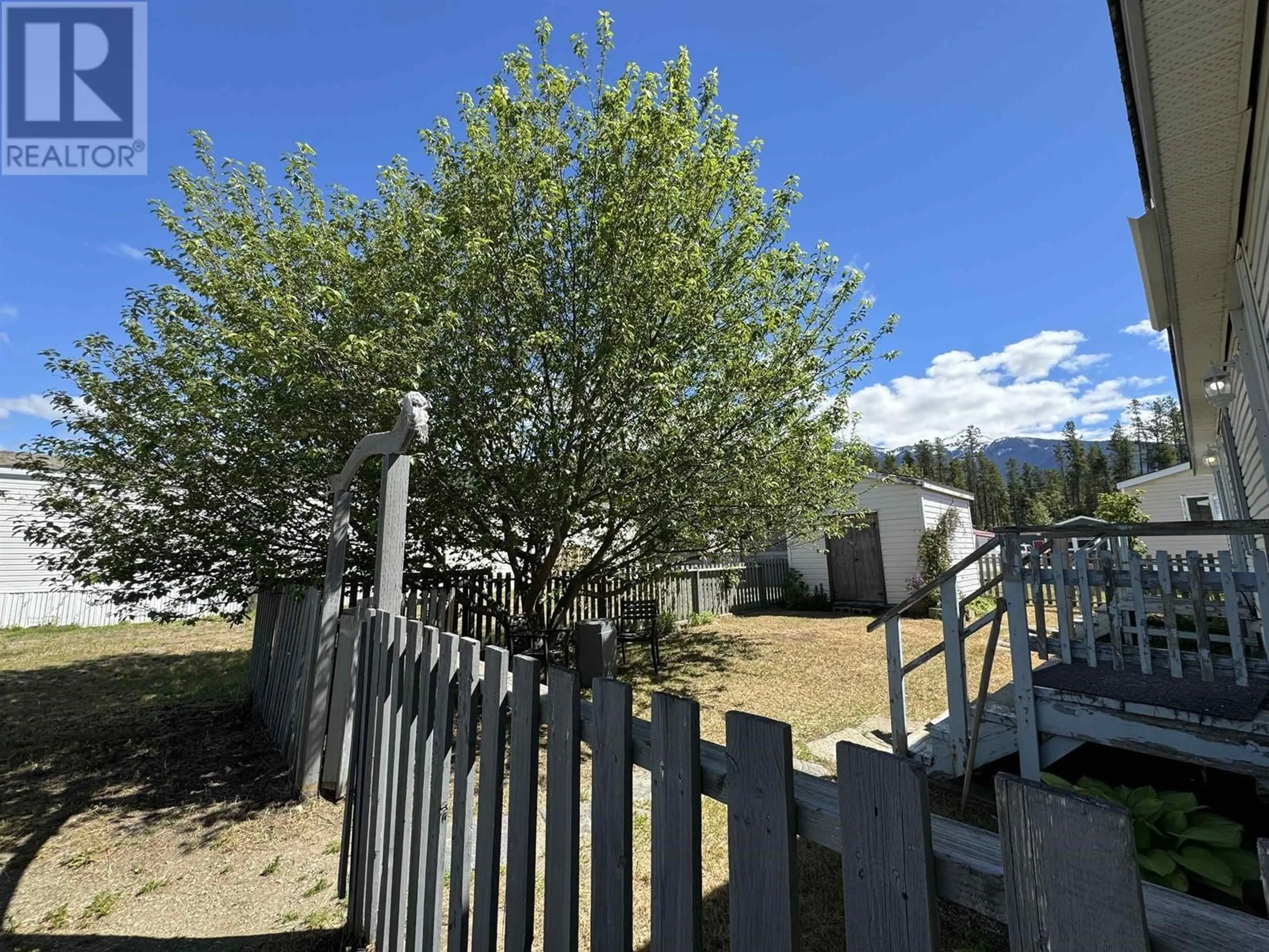 A pic from exterior of the house or condo, the fenced backyard for 12 955 13TH AVENUE, Valemount British Columbia V0E2Z0