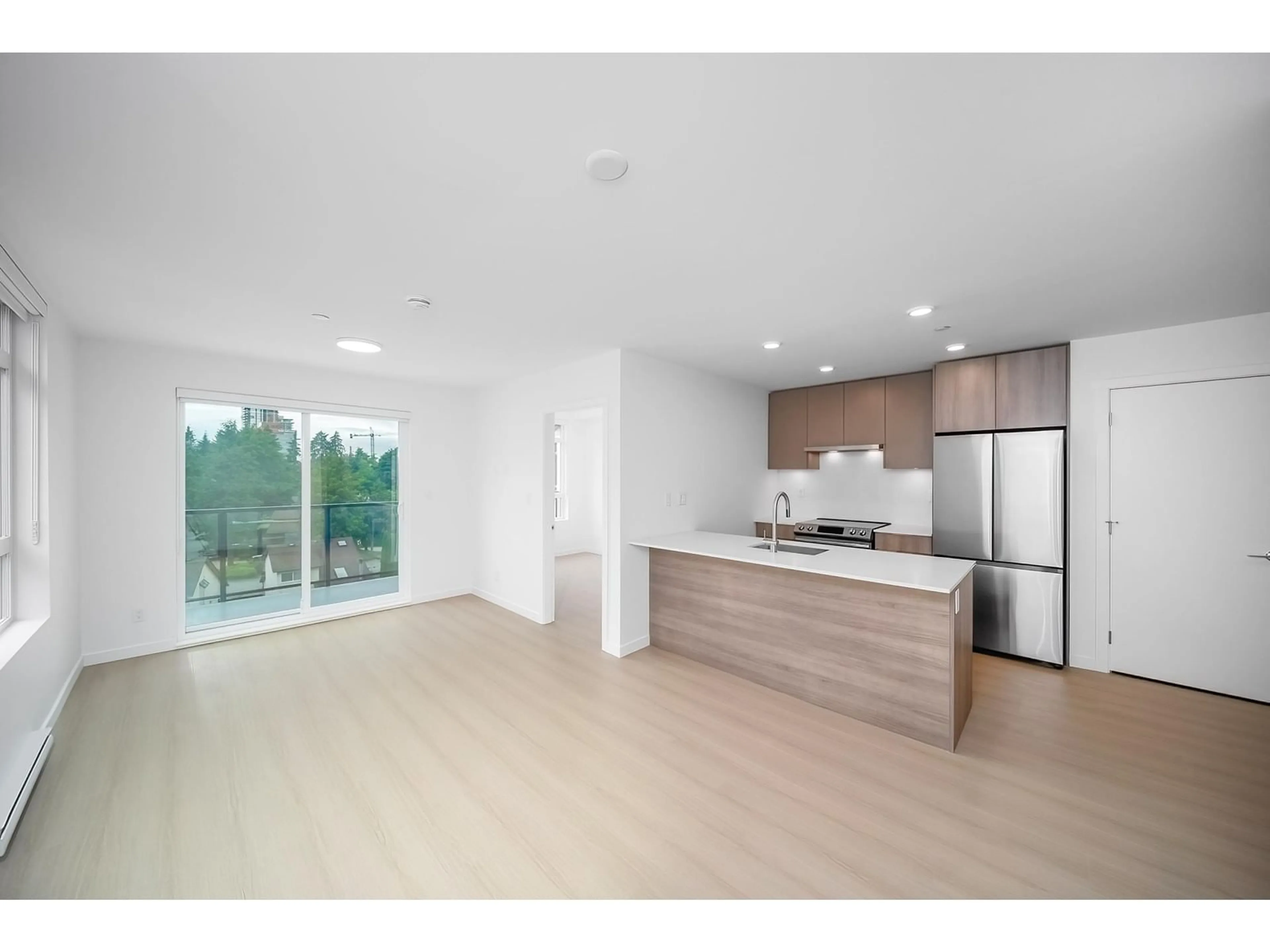 Open concept kitchen, wood/laminate floor for 520 - 13968 LAUREL, Surrey British Columbia V3T0S9