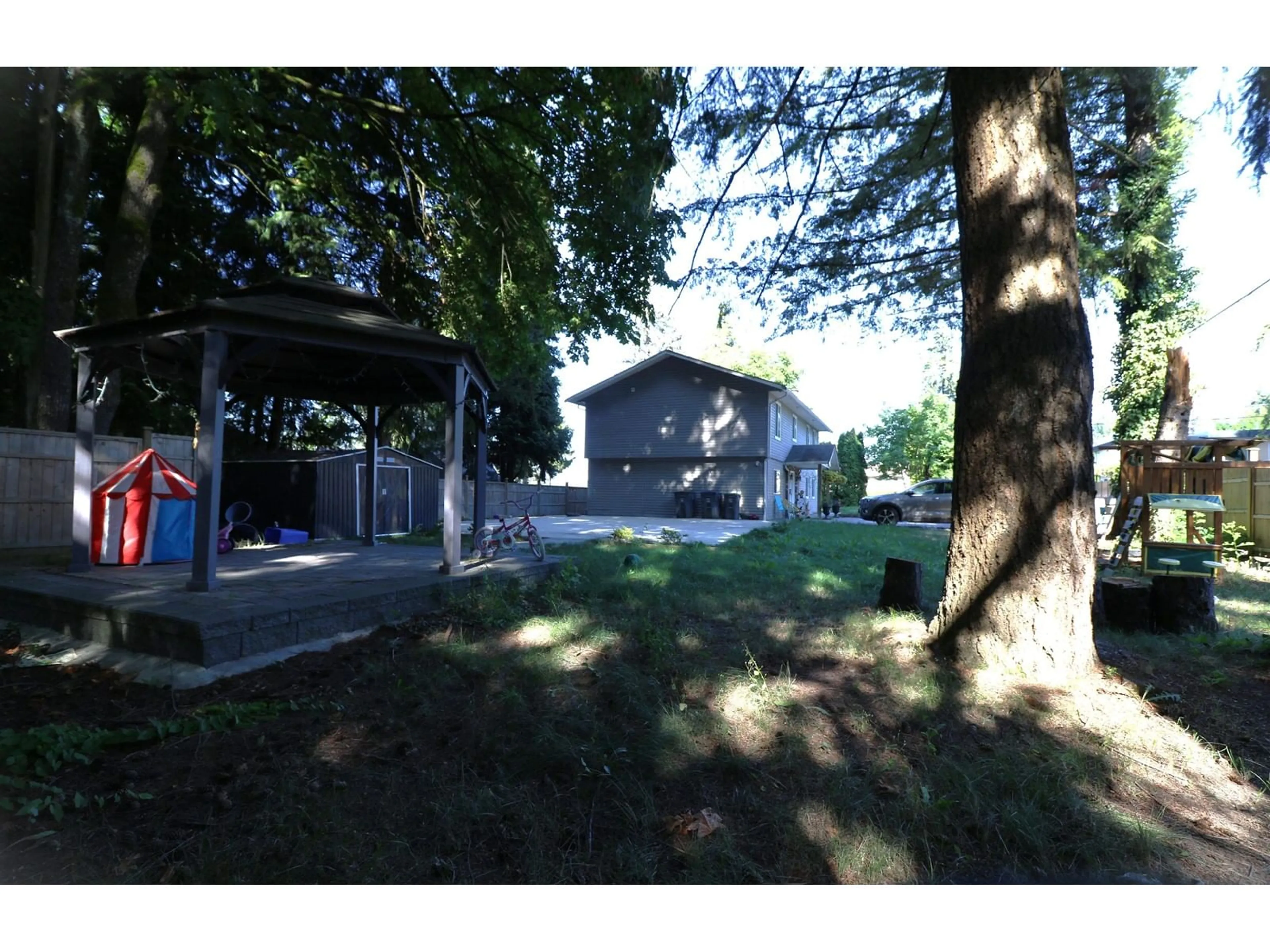 A pic from exterior of the house or condo, the fenced backyard for 7857 140 STREET, Surrey British Columbia V3W5K5