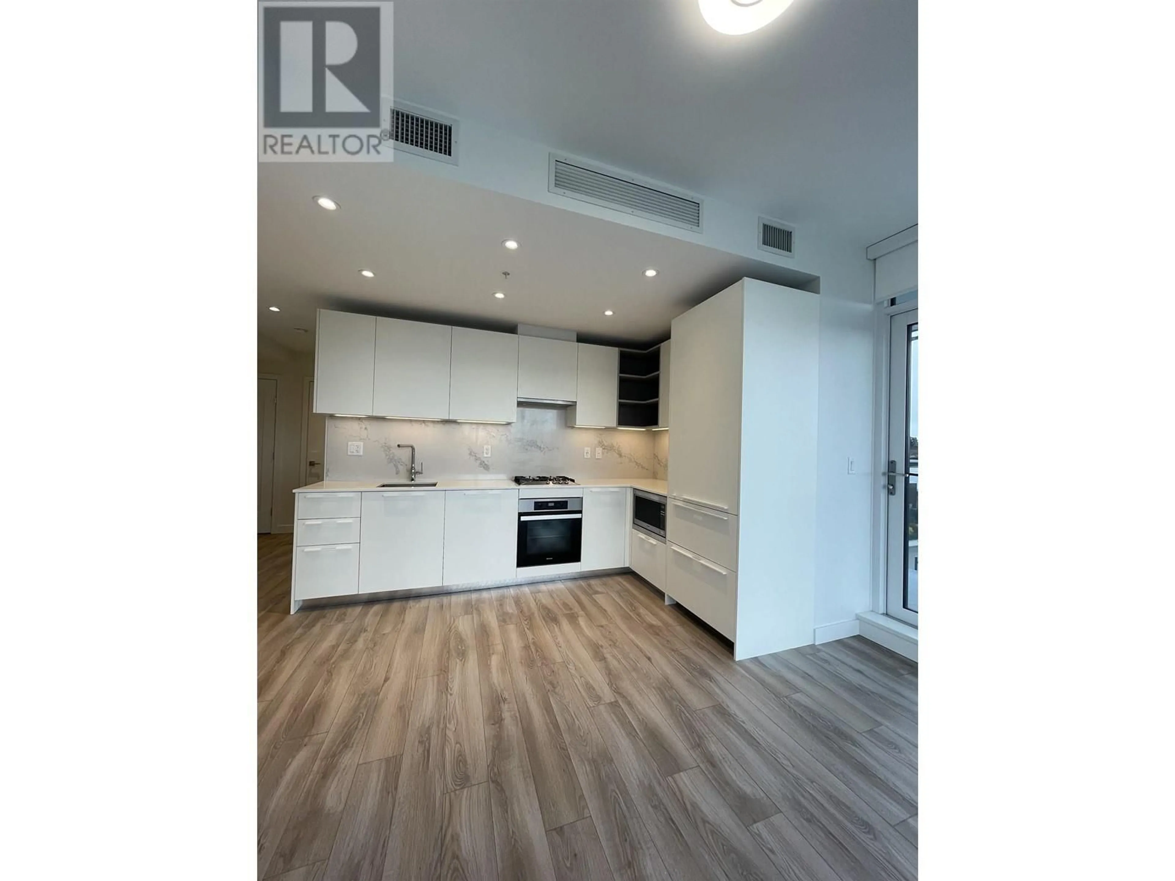 Open concept kitchen, wood/laminate floor for 407 - 6699 DUNBLANE AVENUE, Burnaby British Columbia V5H0J8