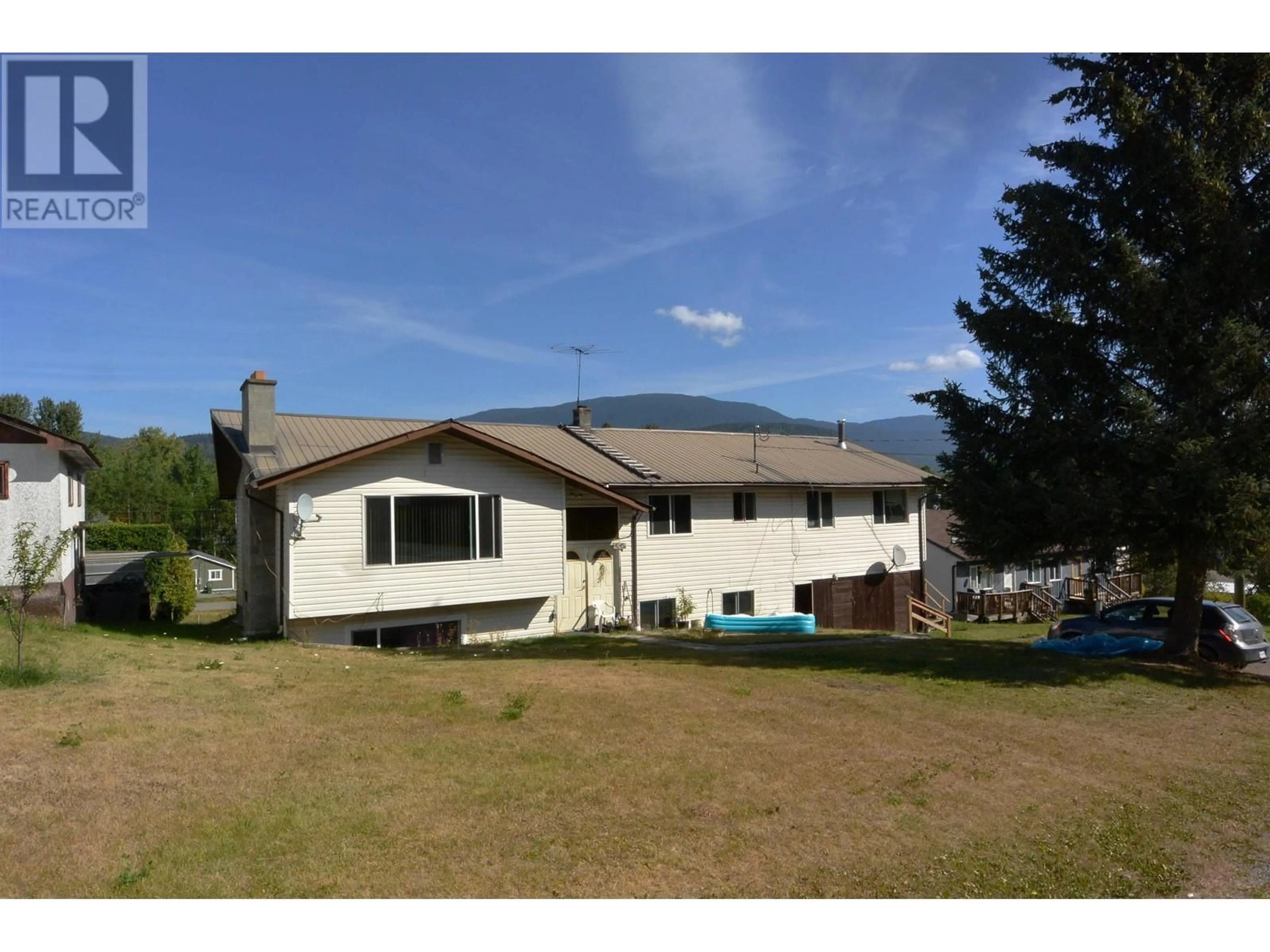 Frontside or backside of a home, the fenced backyard for 4045 6TH AVENUE, New Hazelton British Columbia V0J2J0