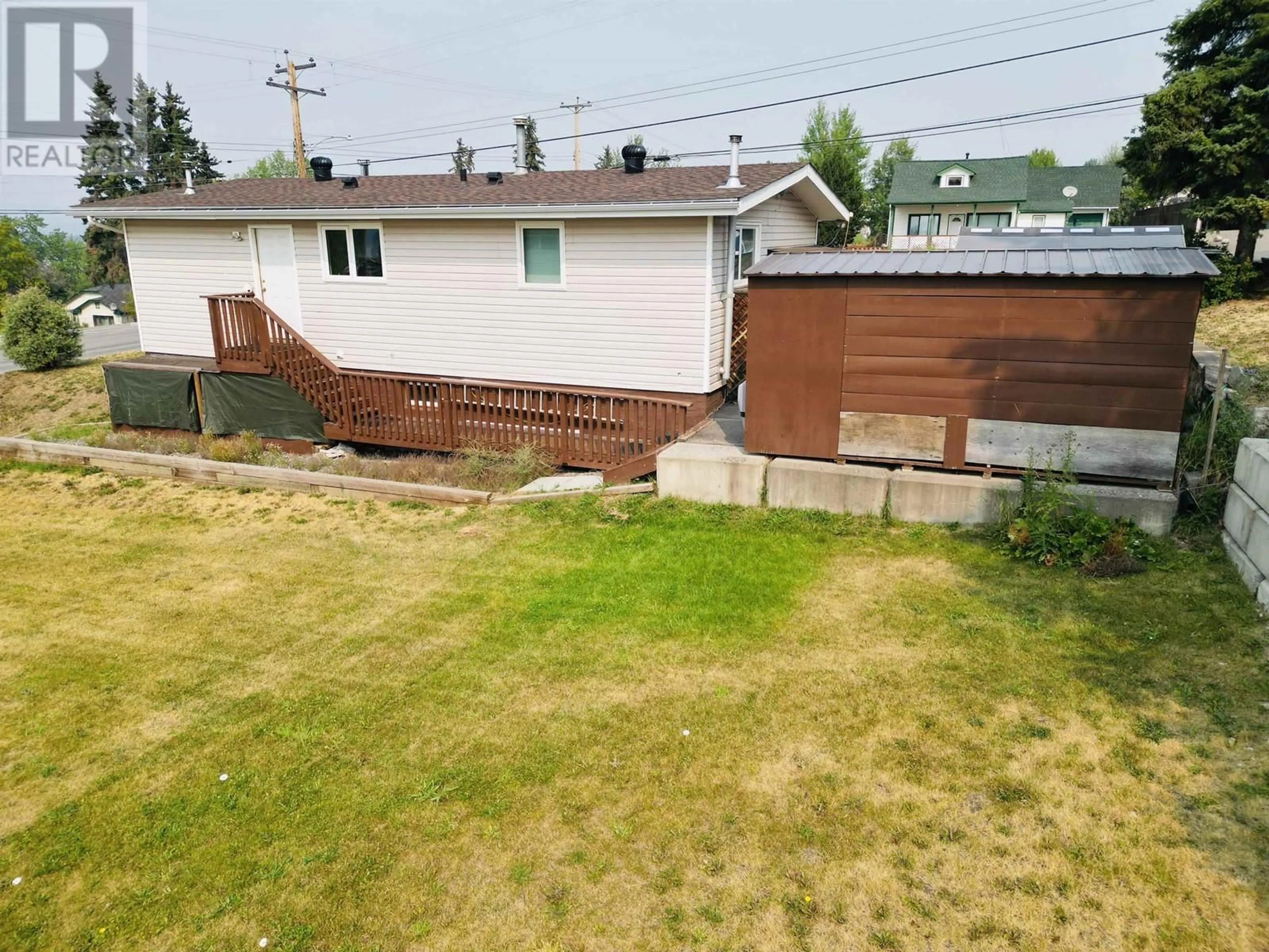 Frontside or backside of a home, the fenced backyard for 512 CENTER STREET, Burns Lake British Columbia V0J1E0