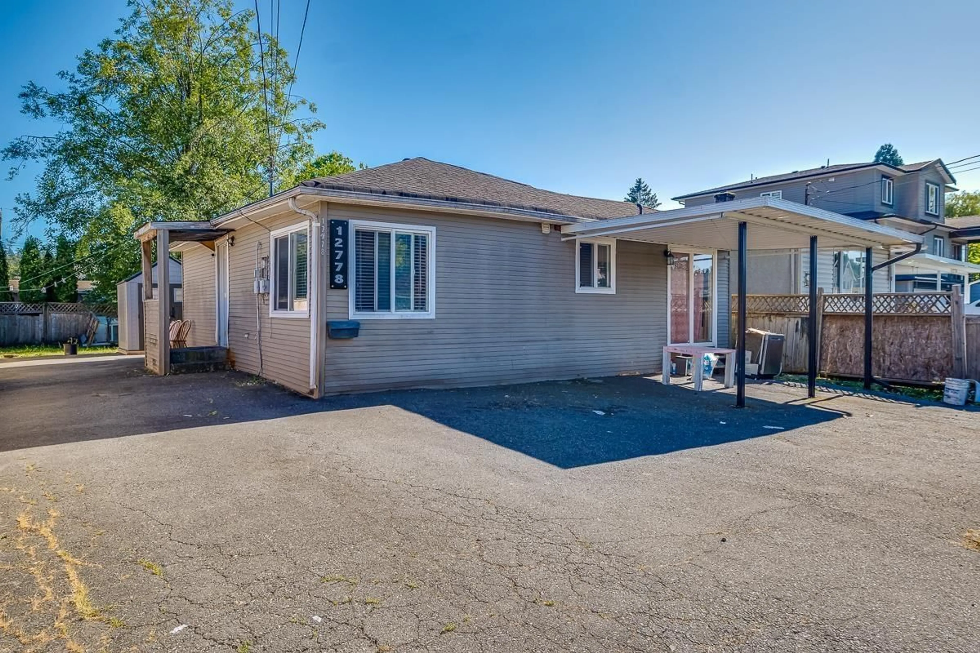 Frontside or backside of a home, the fenced backyard for 12778 114 AVENUE, Surrey British Columbia V3V3P1