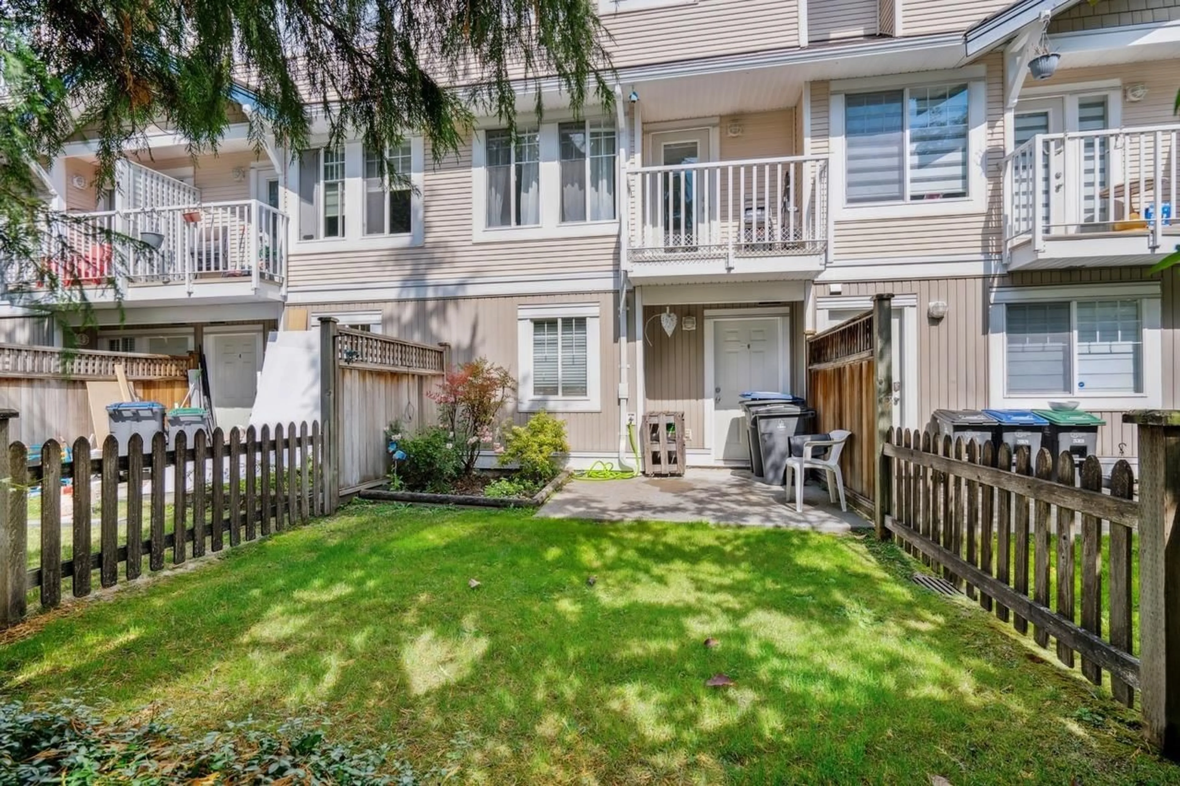 A pic from exterior of the house or condo, the fenced backyard for 40 6533 121 STREET, Surrey British Columbia V3W1M5