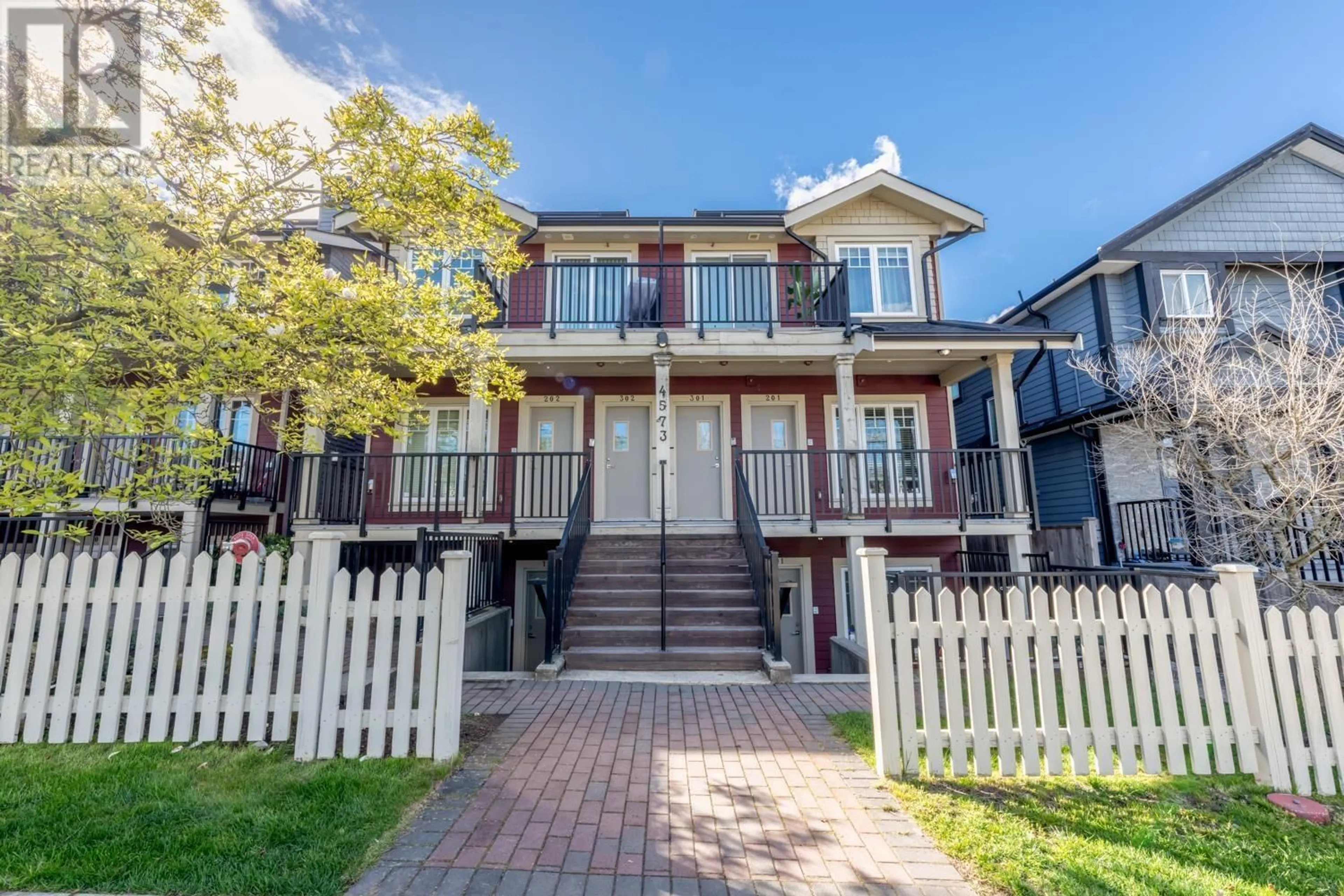 A pic from exterior of the house or condo, the fenced backyard for 201 4573 SLOCAN STREET, Vancouver British Columbia V5R1Z8